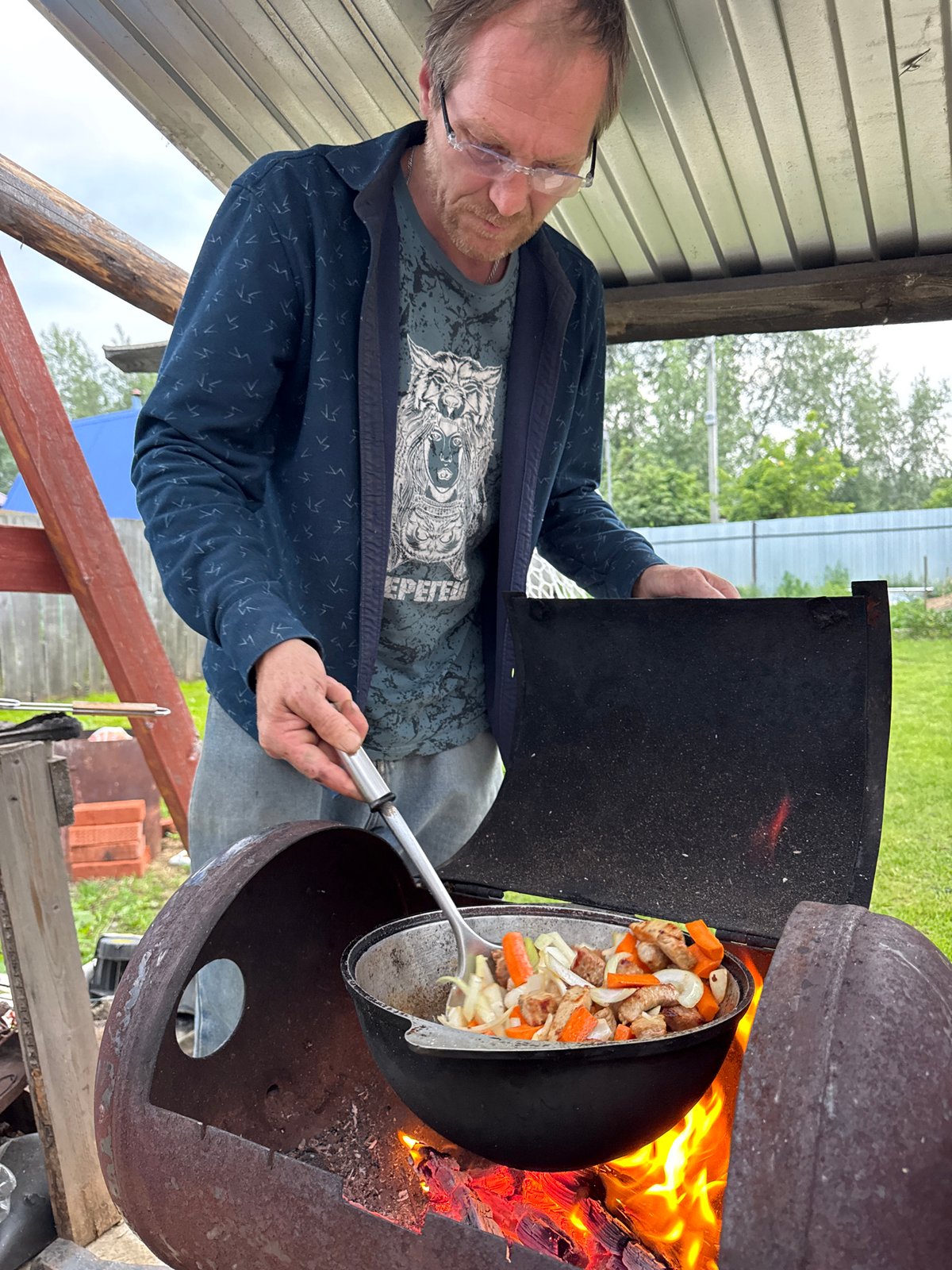 Outdoor pot cooking under a canopy in Chaikovsky, Russia