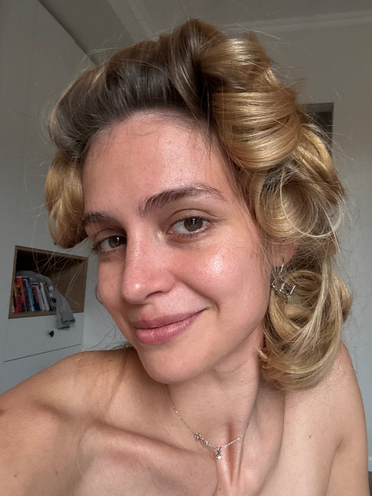 Blonde woman photographed in indoor portrait session with styled curls