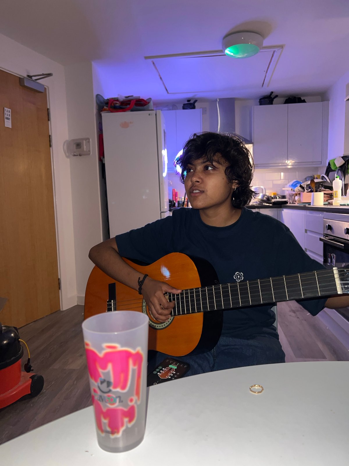 Late night apartment gathering features guitar music and photos