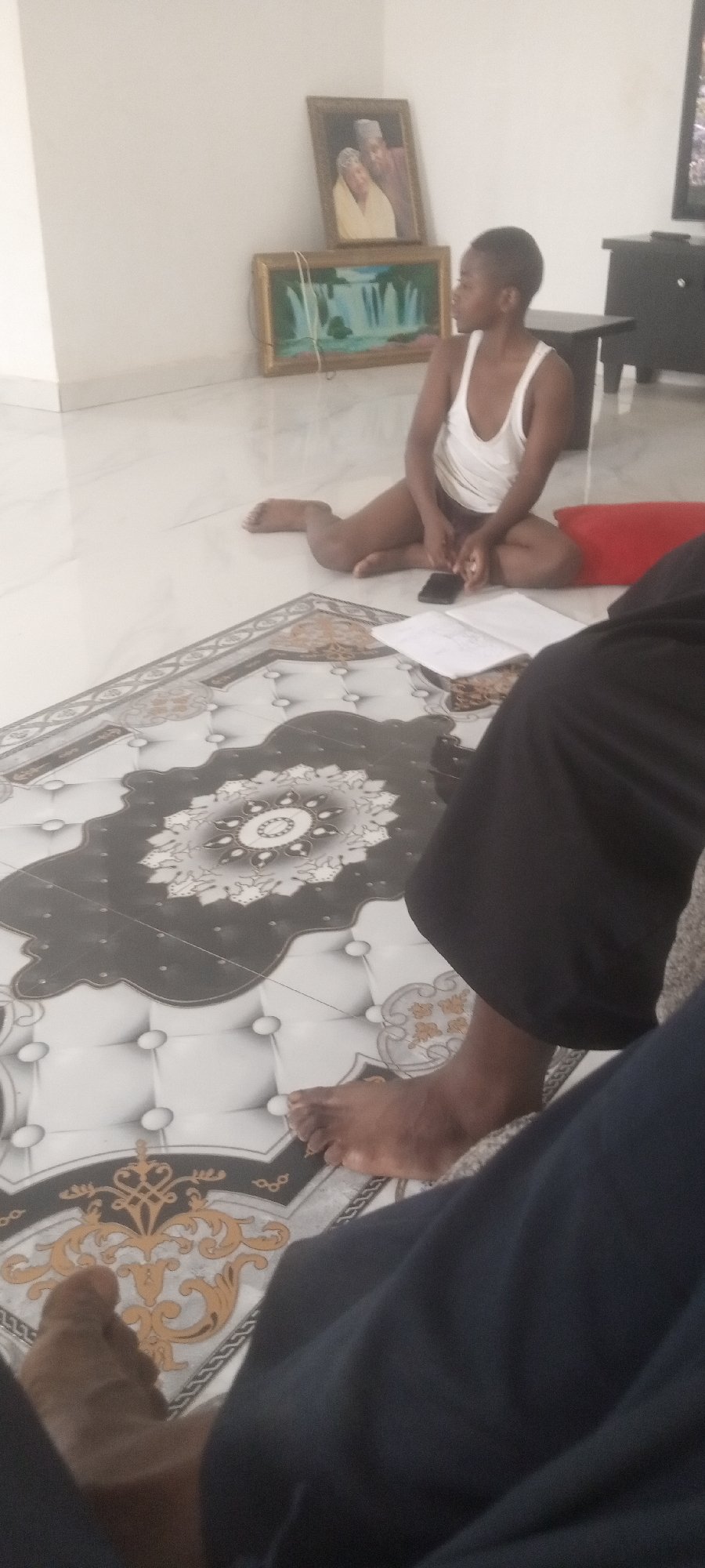 Young person photographed reading indoors in Narayi, Nigeria