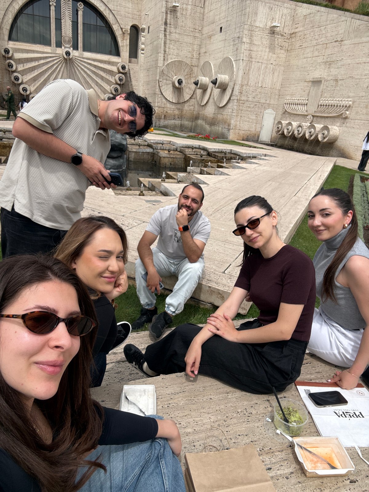 Tourist explores Yerevan's Cascade monument, capturing sculptures and fountains