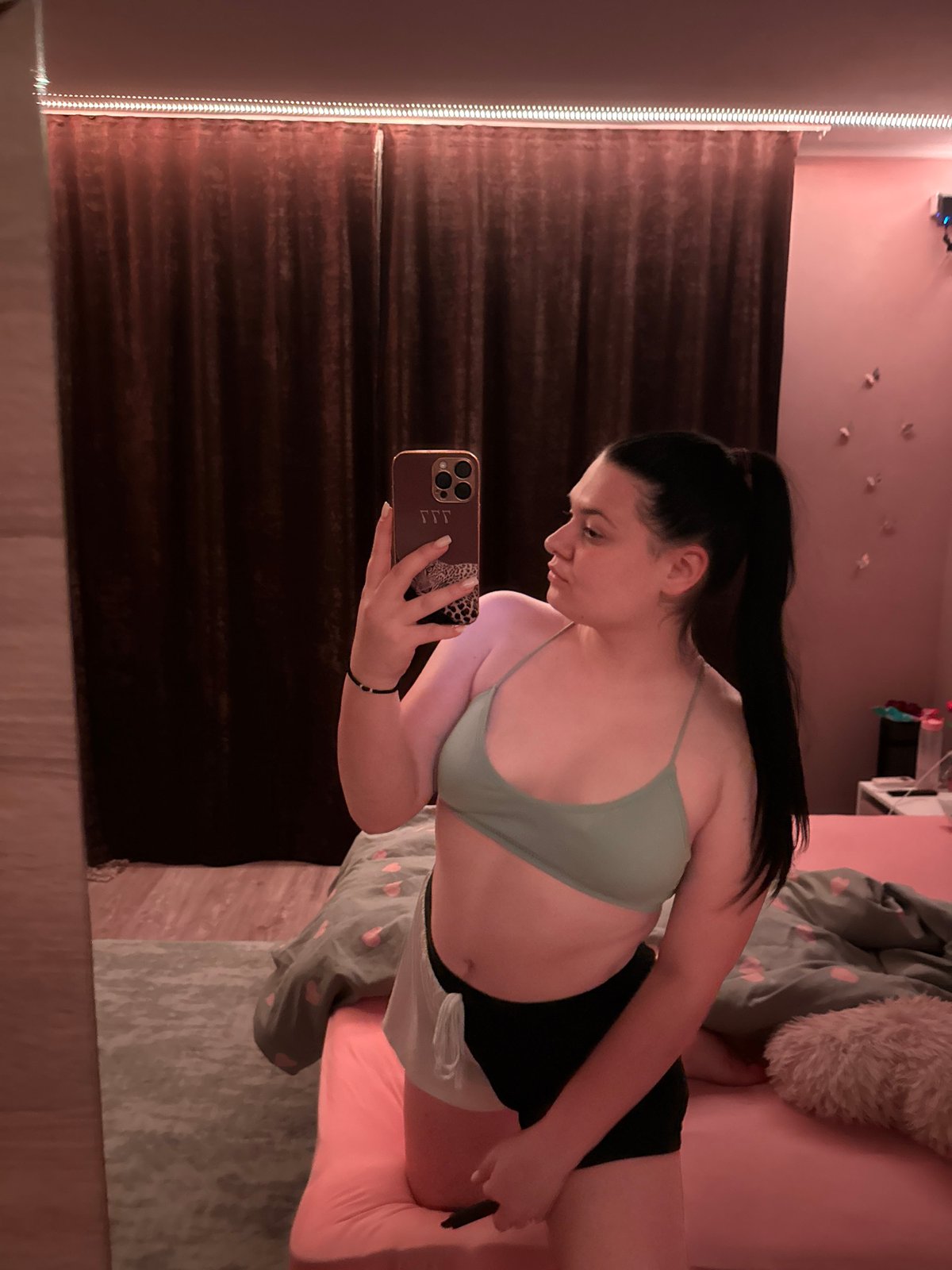Woman takes mirror selfies in bedroom in Rogosh, Bulgaria