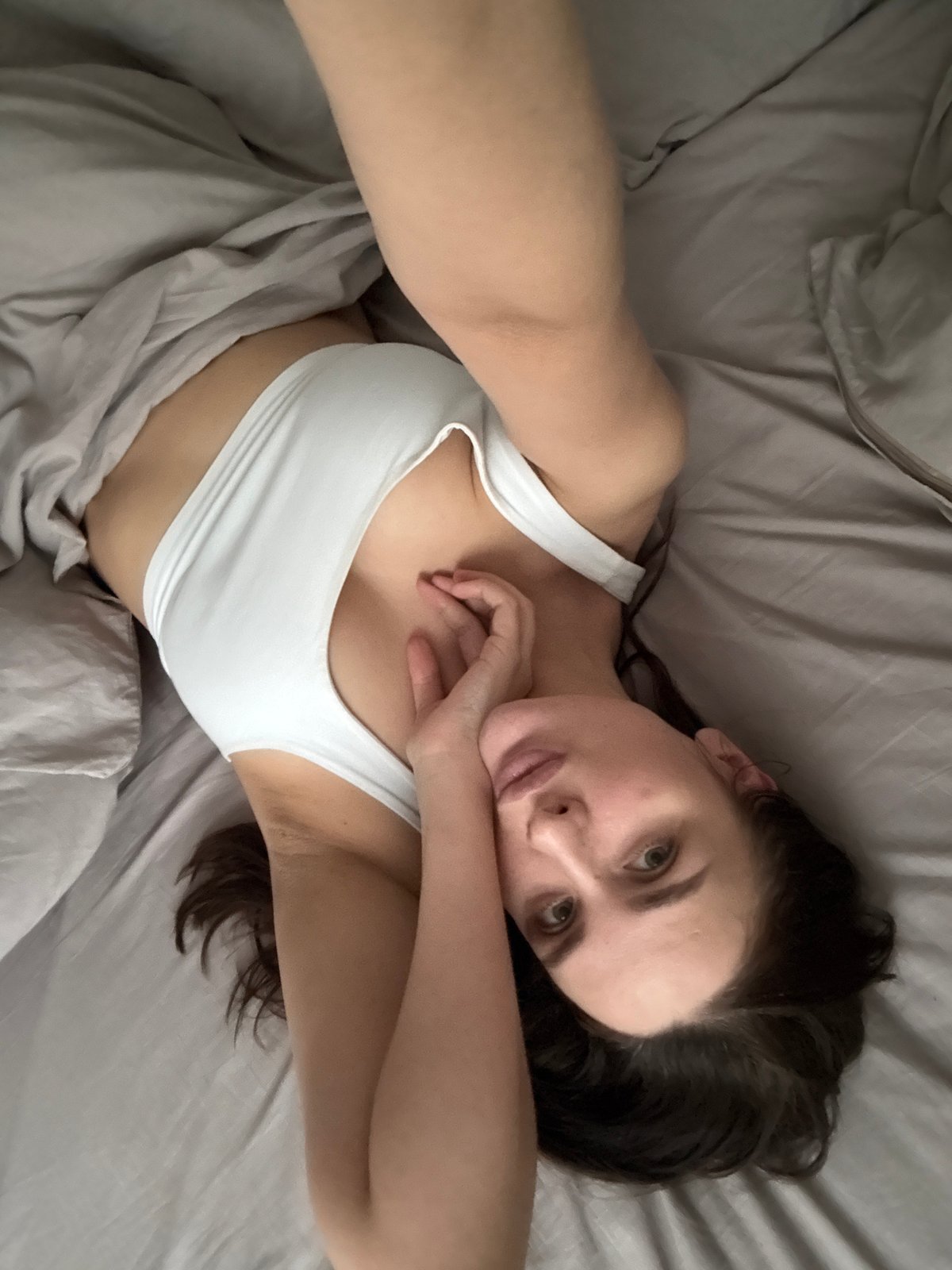 Woman resting on bed in Chaikovsky, Russia morning