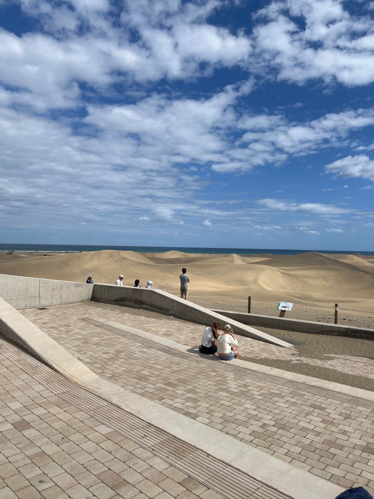 Visitors gather at coastal viewing area in Gran Canaria
