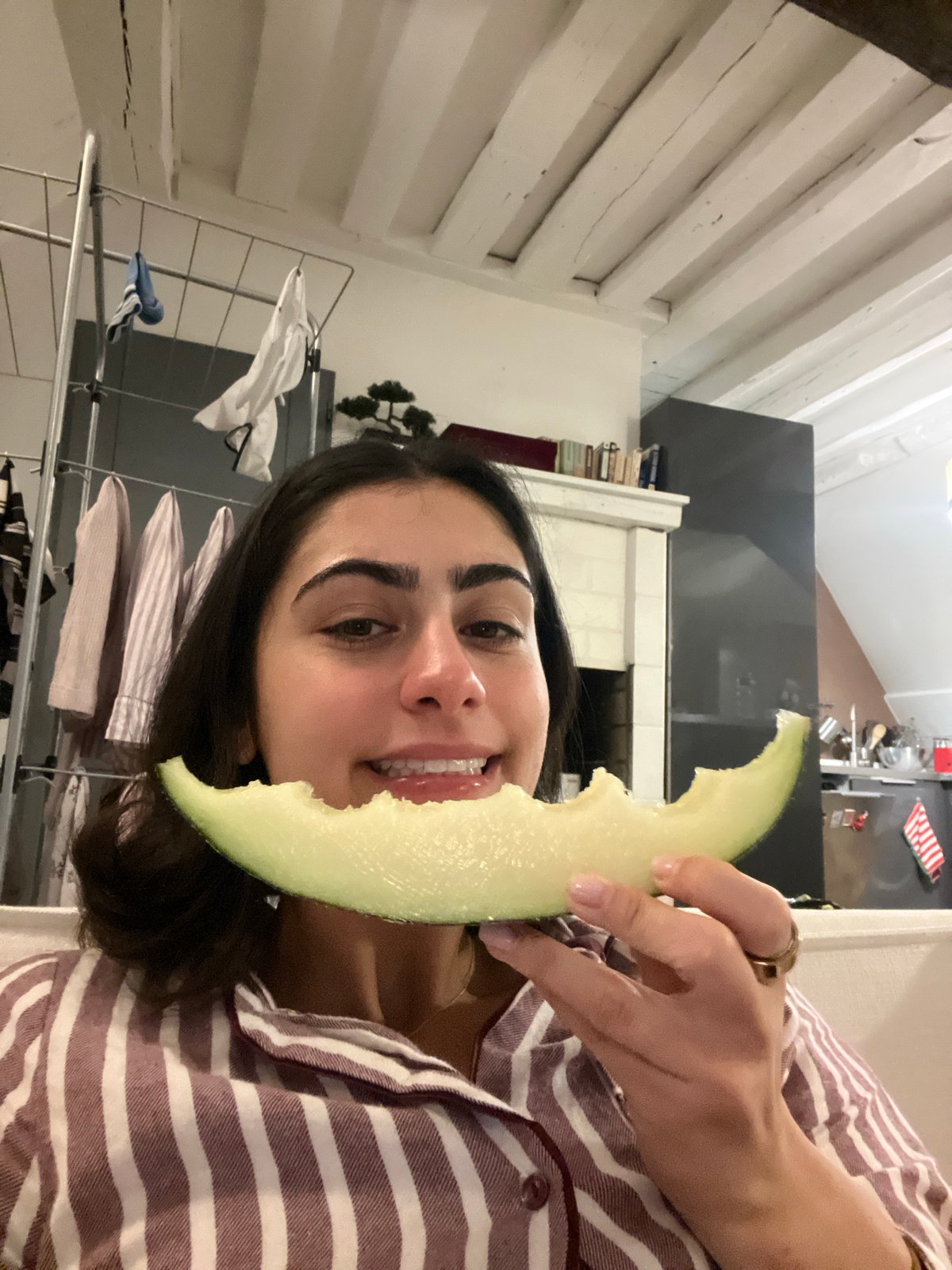 Woman enjoys melon snack in Paris kitchen