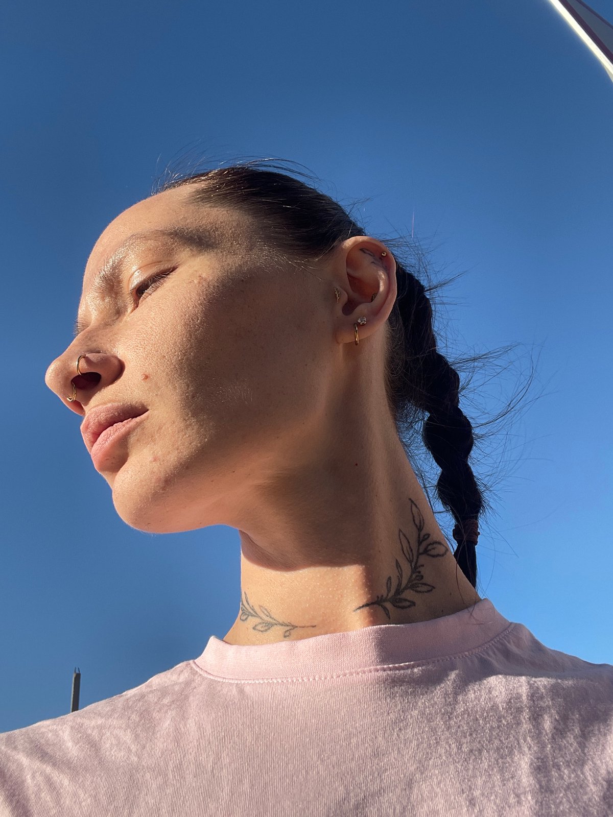 Woman with braided hair, piercings observed in Pervomaysky