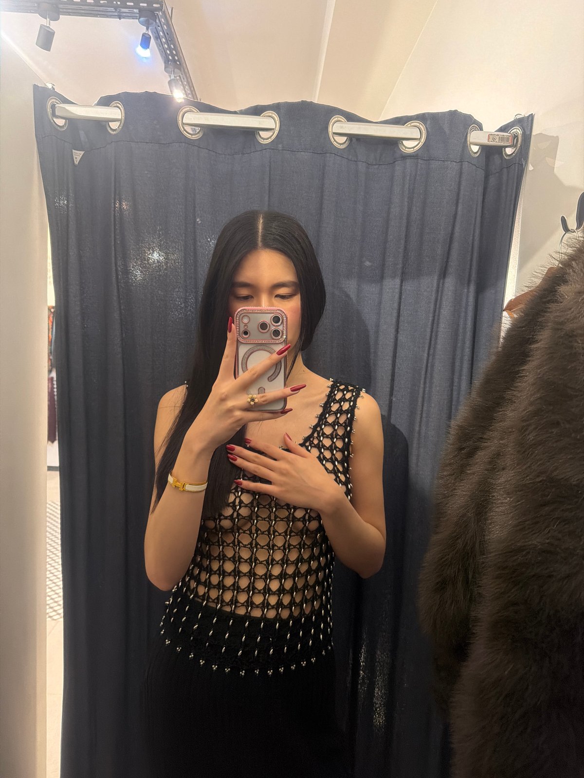 Woman takes selfie with pink iPhone in Paris