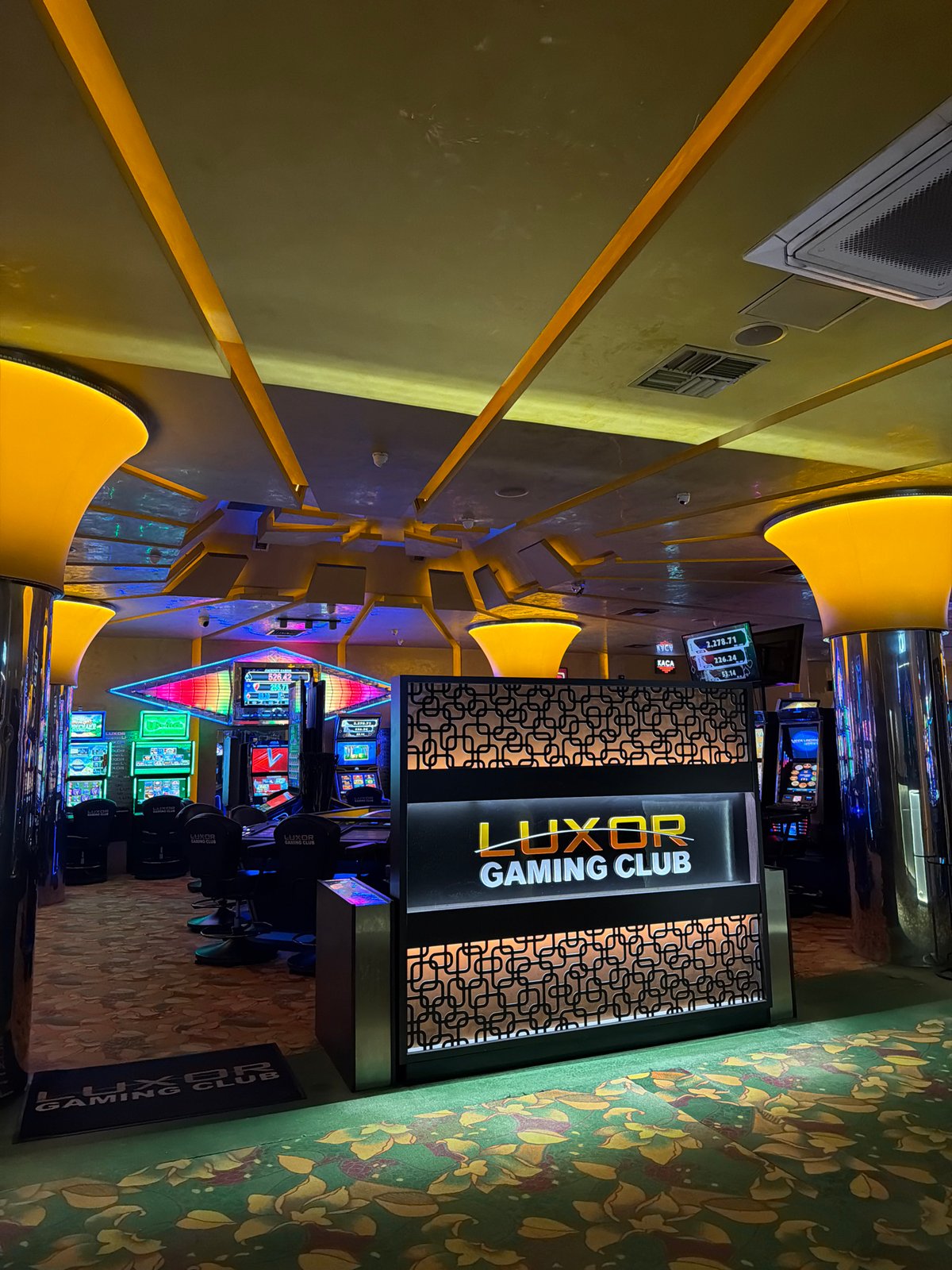 Gaming club interior captured with illuminated displays and machines