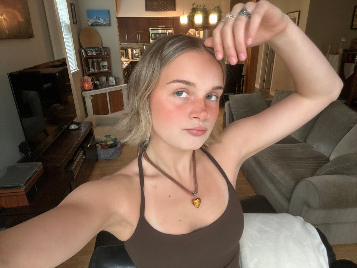 Woman takes selfies on couch in Whistler