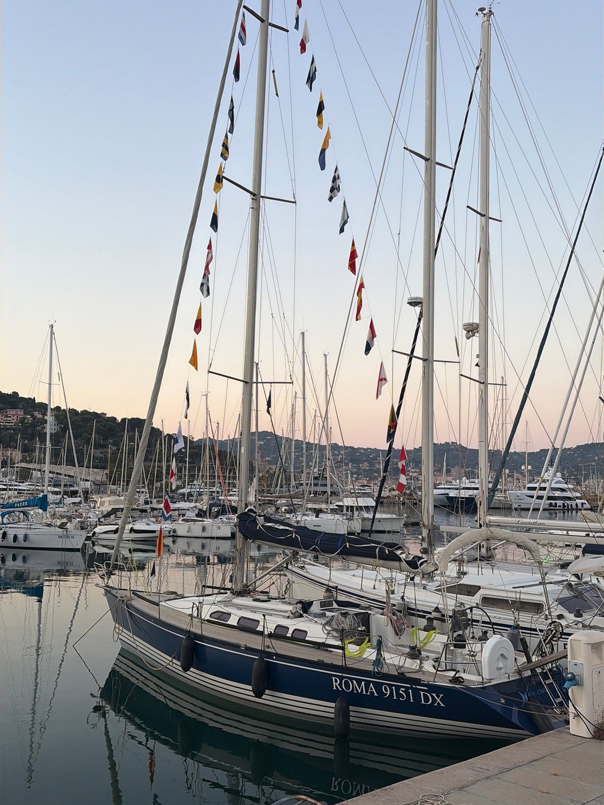 Imperia's marina at dusk, seagulls and sailboats
