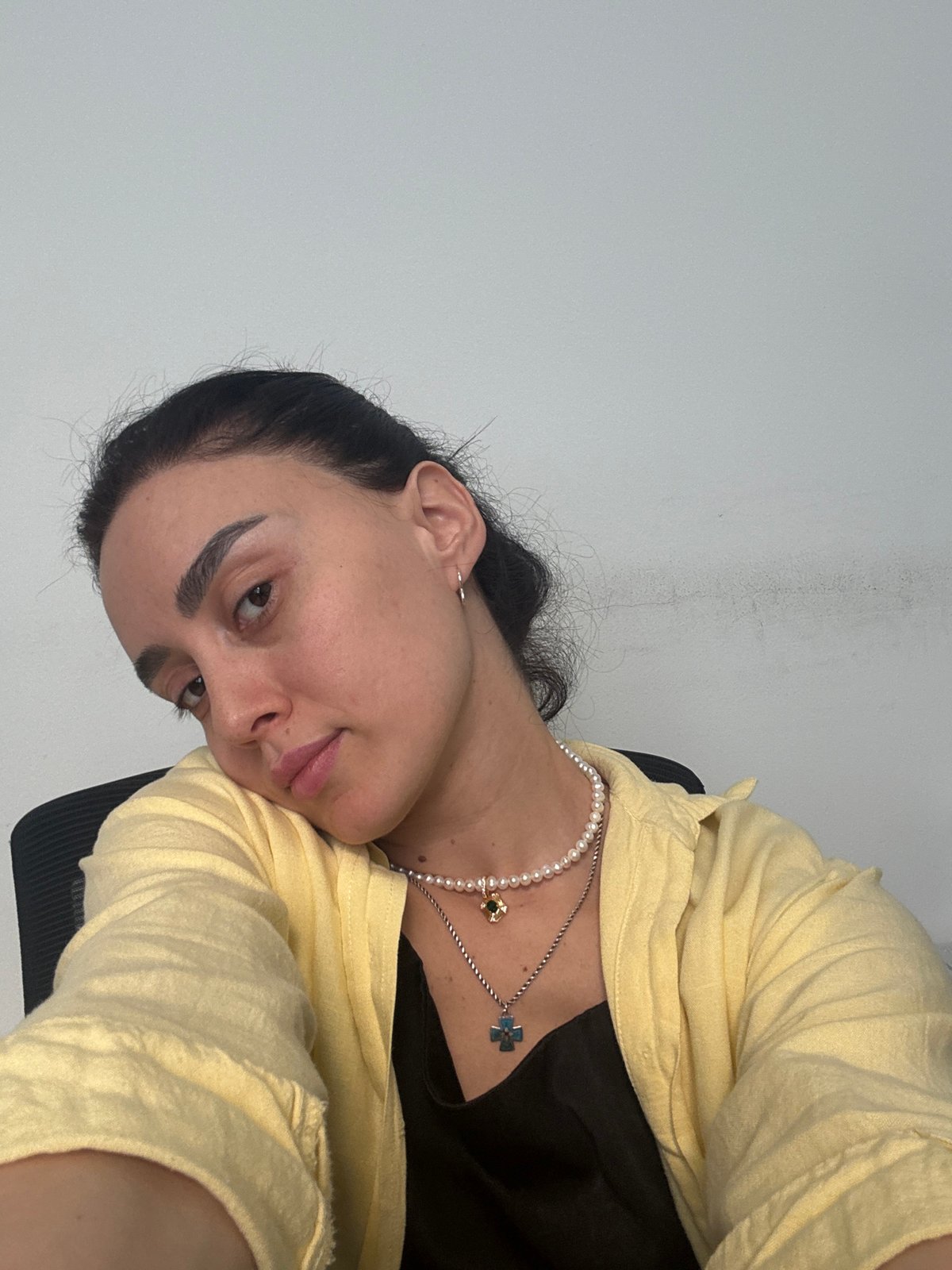 Woman photographed indoors in yellow shirt in Tbilisi