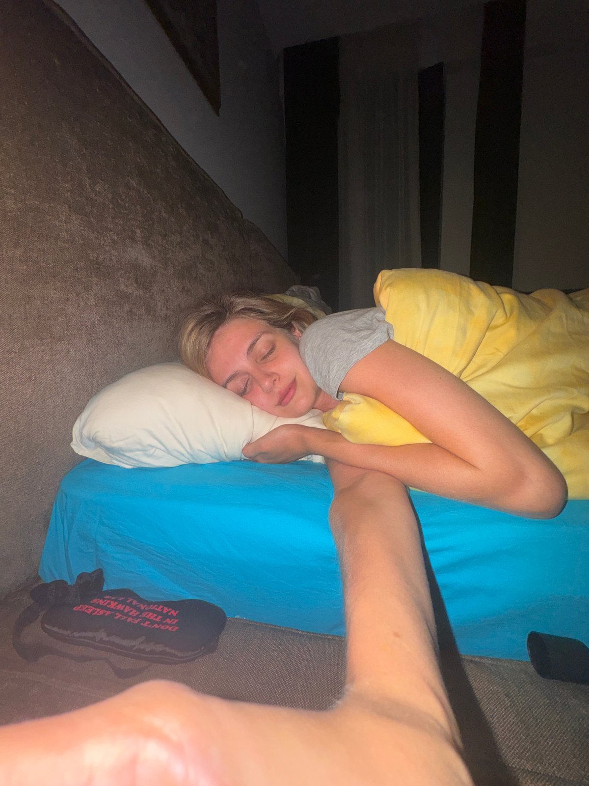 Woman rests wearing mysterious Hawking National Lab sleep mask