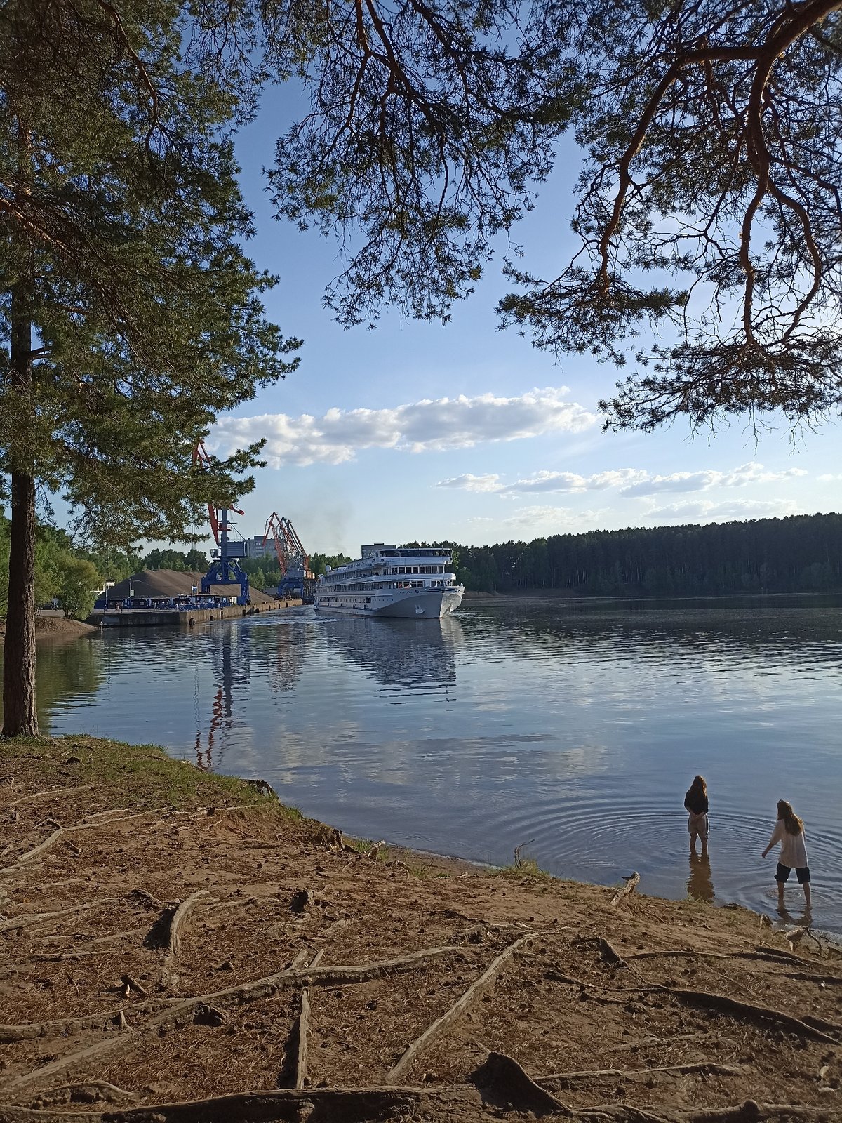 Witnesses capture peaceful waterfront park scene with passenger ship