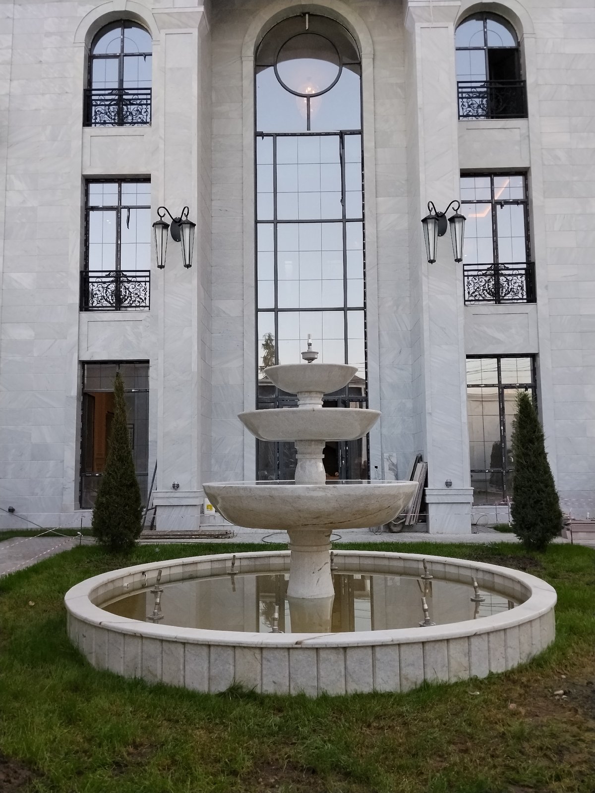 Marble-clad building with ornate fountain out front