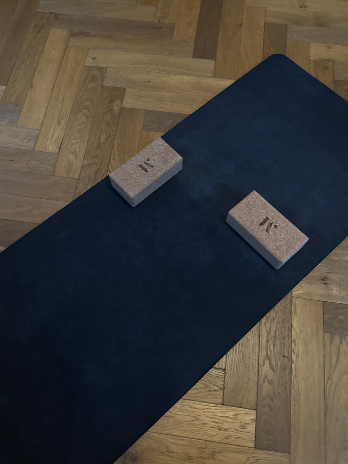 Yoga equipment with branded blocks photographed on London floor