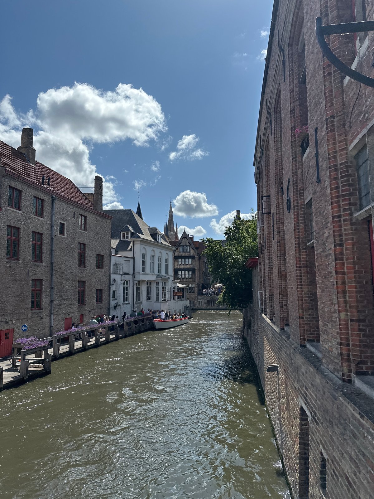 Bruges canals and cobblestone squares on a sunny afternoon