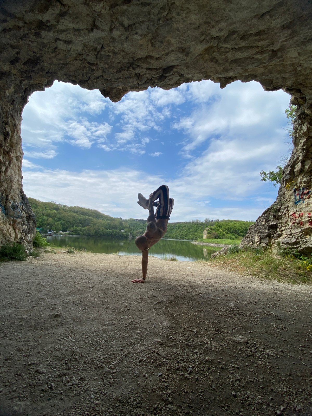 Man performs yoga poses near lake in Pleven, Bulgaria