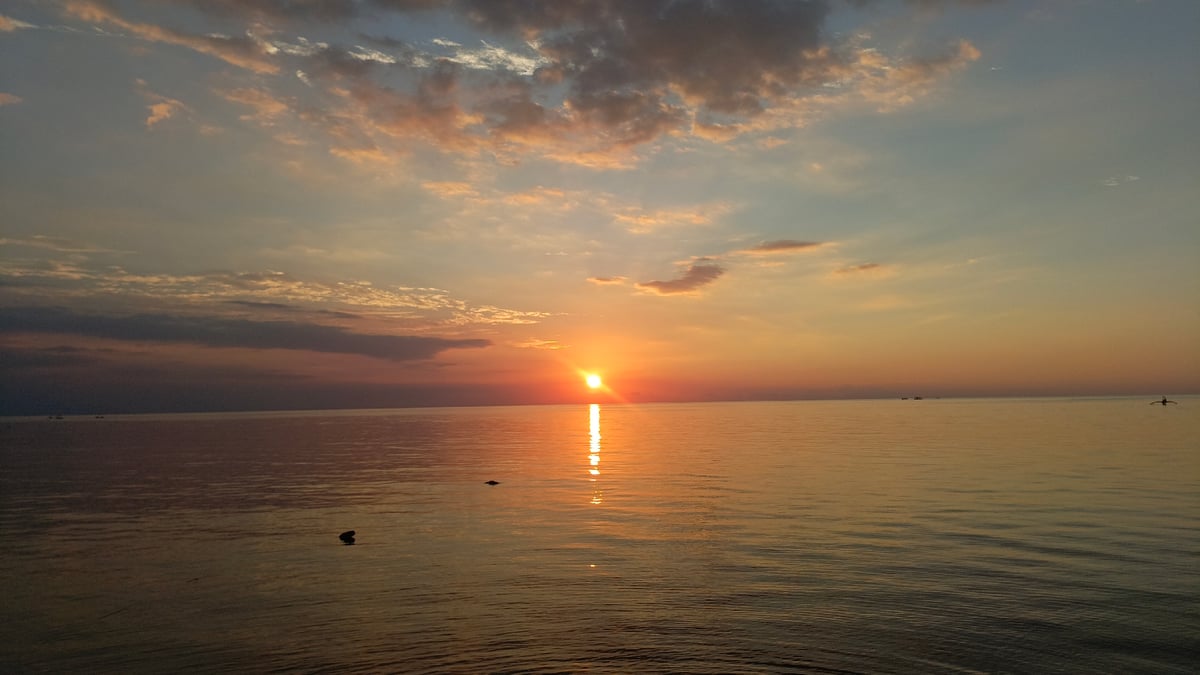 Peaceful sunrise documented along Buleleng coast with traditional boats