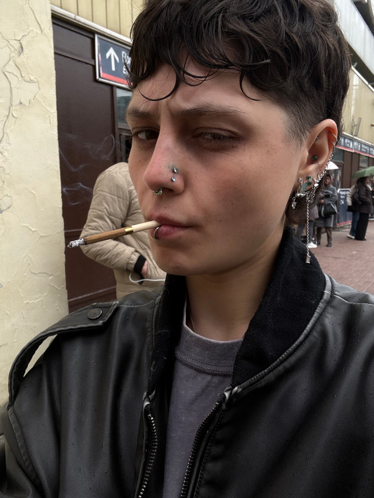 Person films self smoking at busy train station