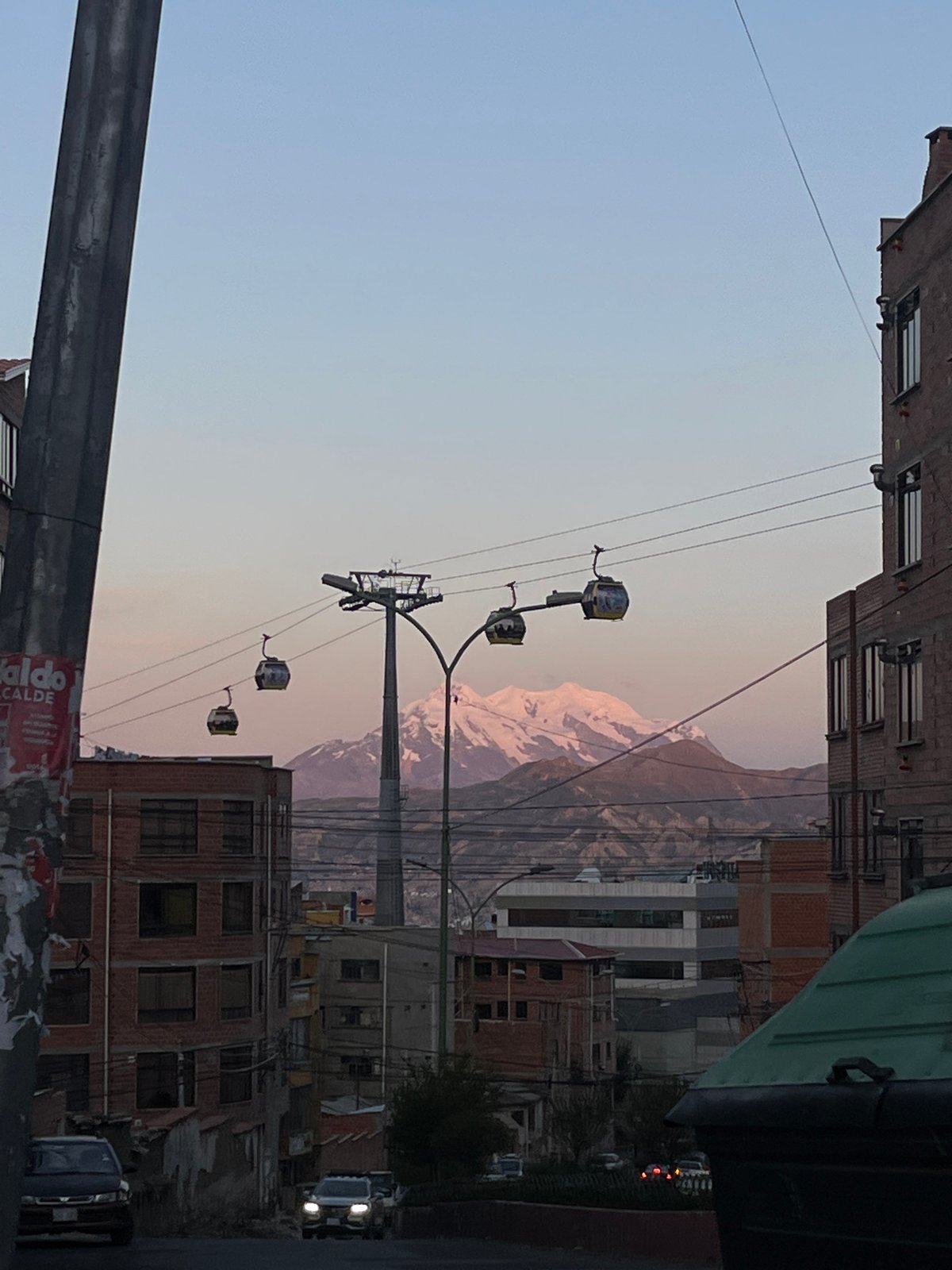 Cable cars operate above La Paz cityscape with mountains