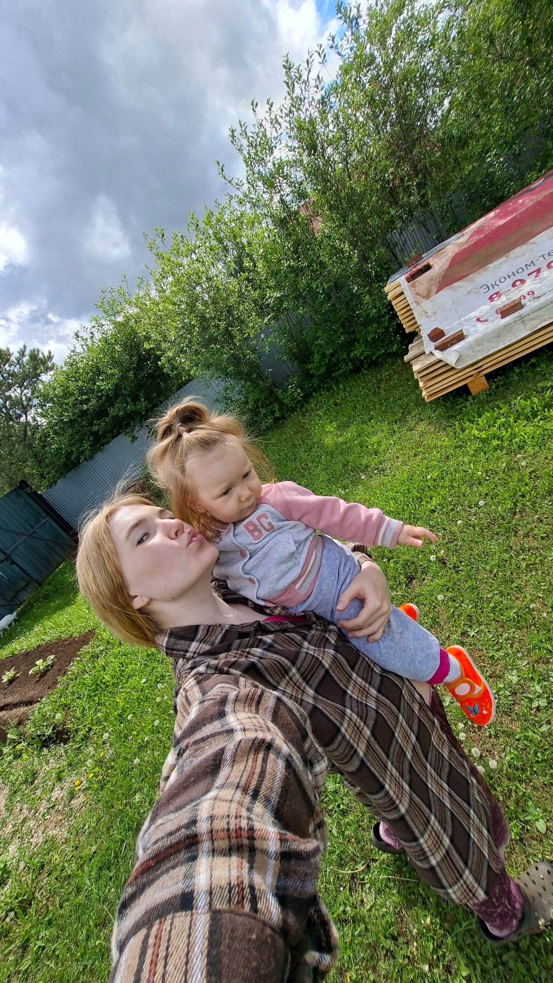 Woman and child enjoy spring morning in Russian village