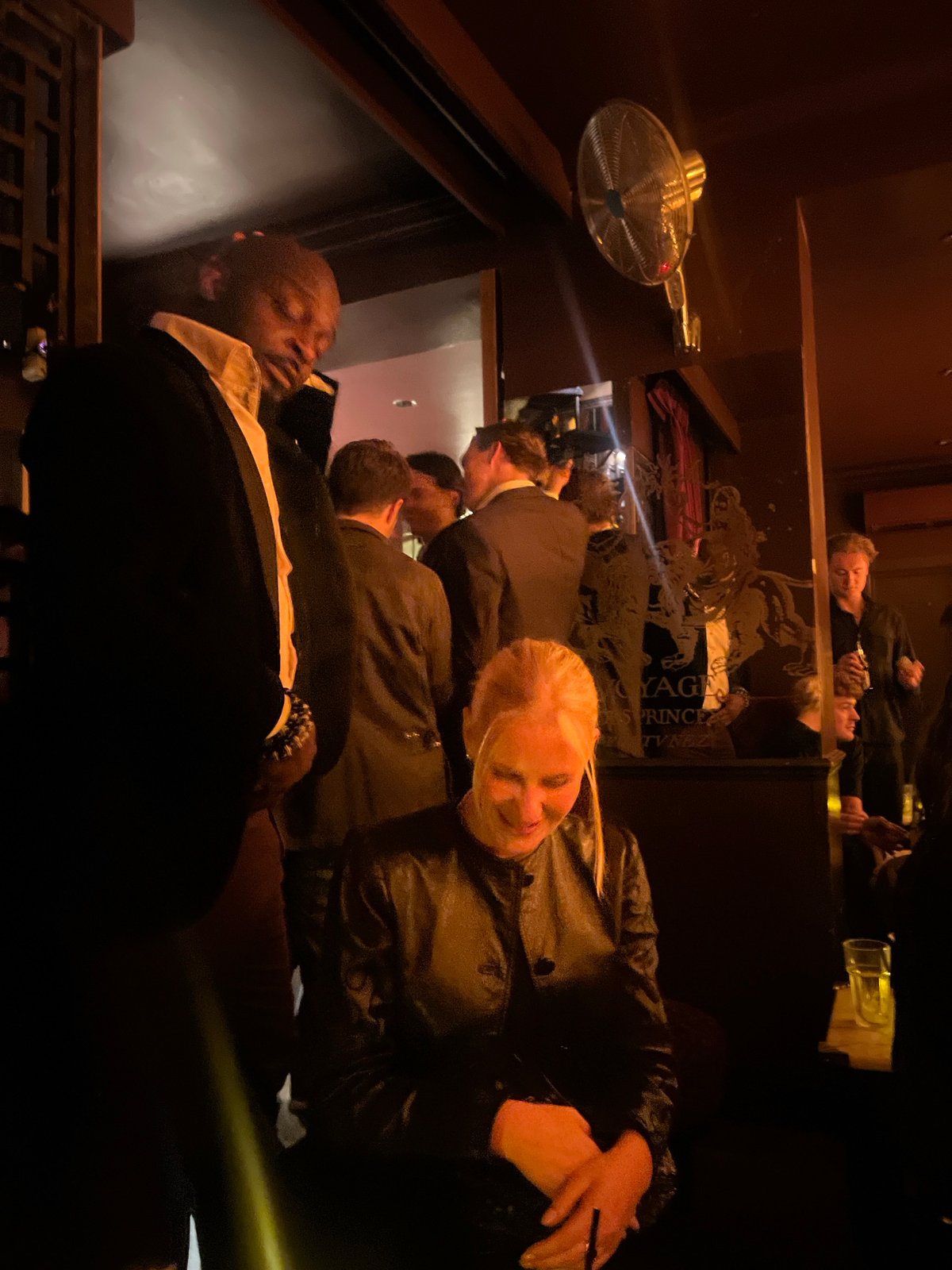 Mixed-attire crowd gathers at London bar Friday night