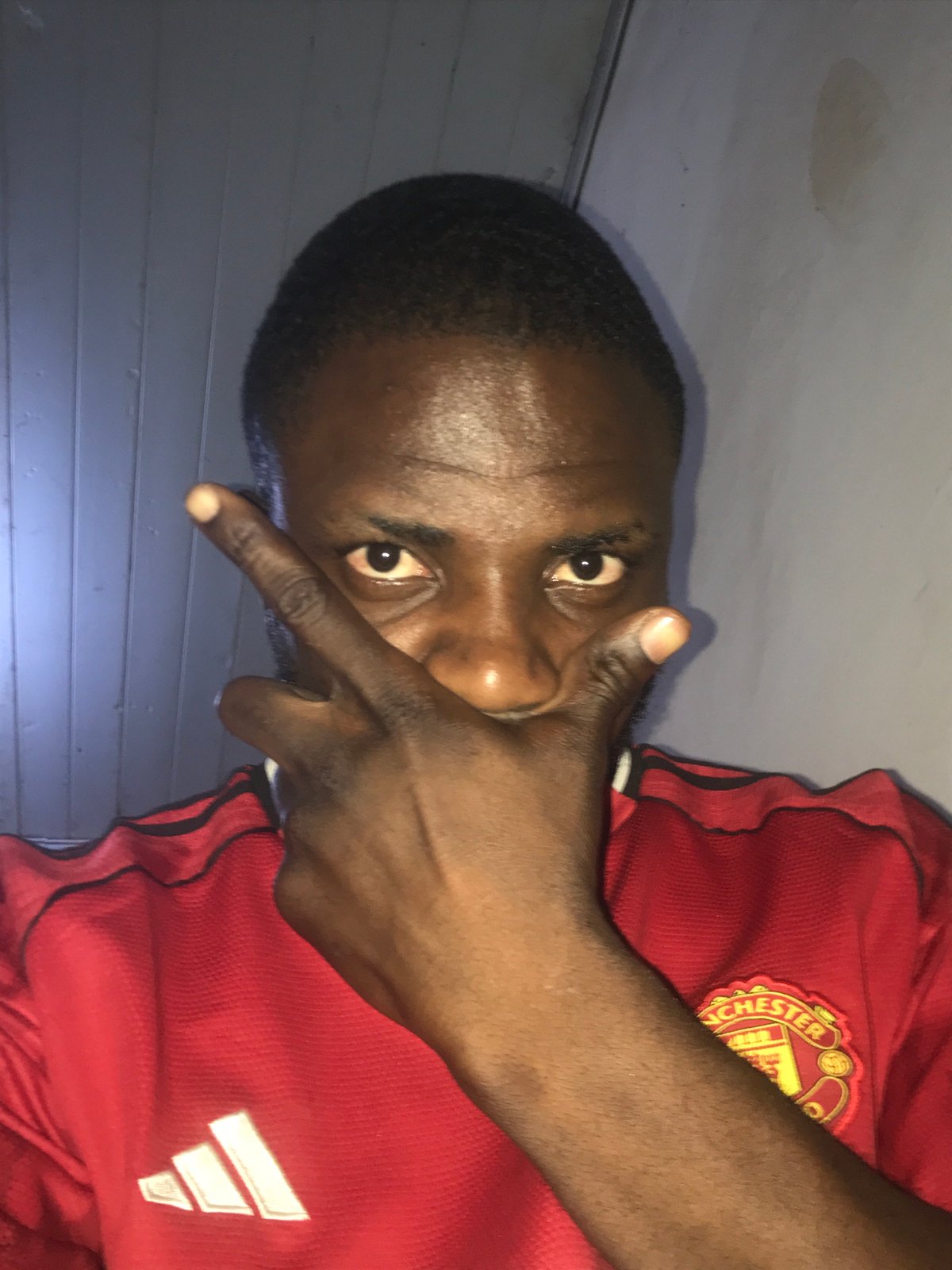 Manchester United fan photographed in informal portrait session, Kabong Nigeria