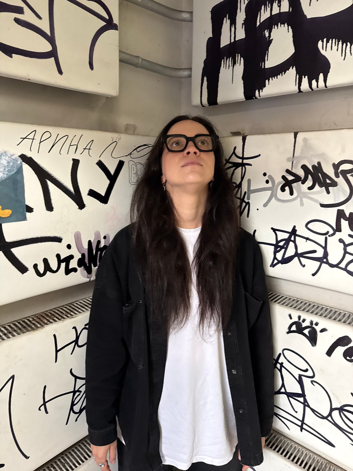 Exploring a graffiti-layered urban stairwell in Izhevsk