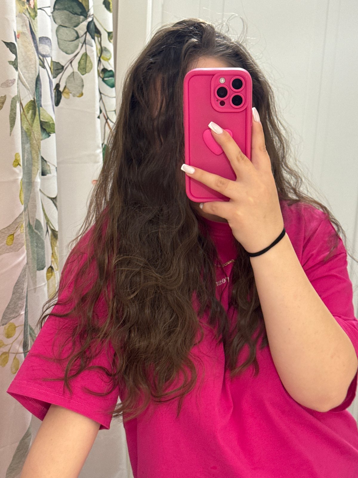 Person takes mirror selfies in pink shirt, Russia