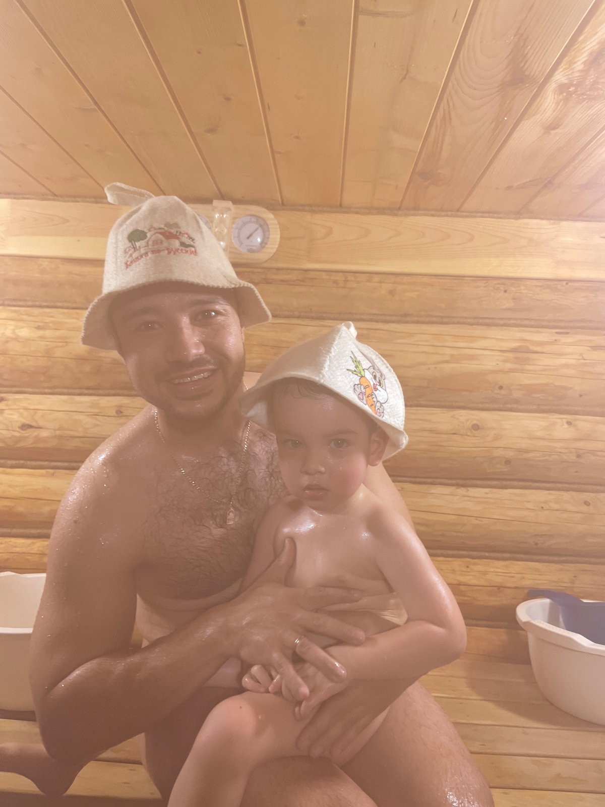Father and child enjoy traditional sauna time in Russia
