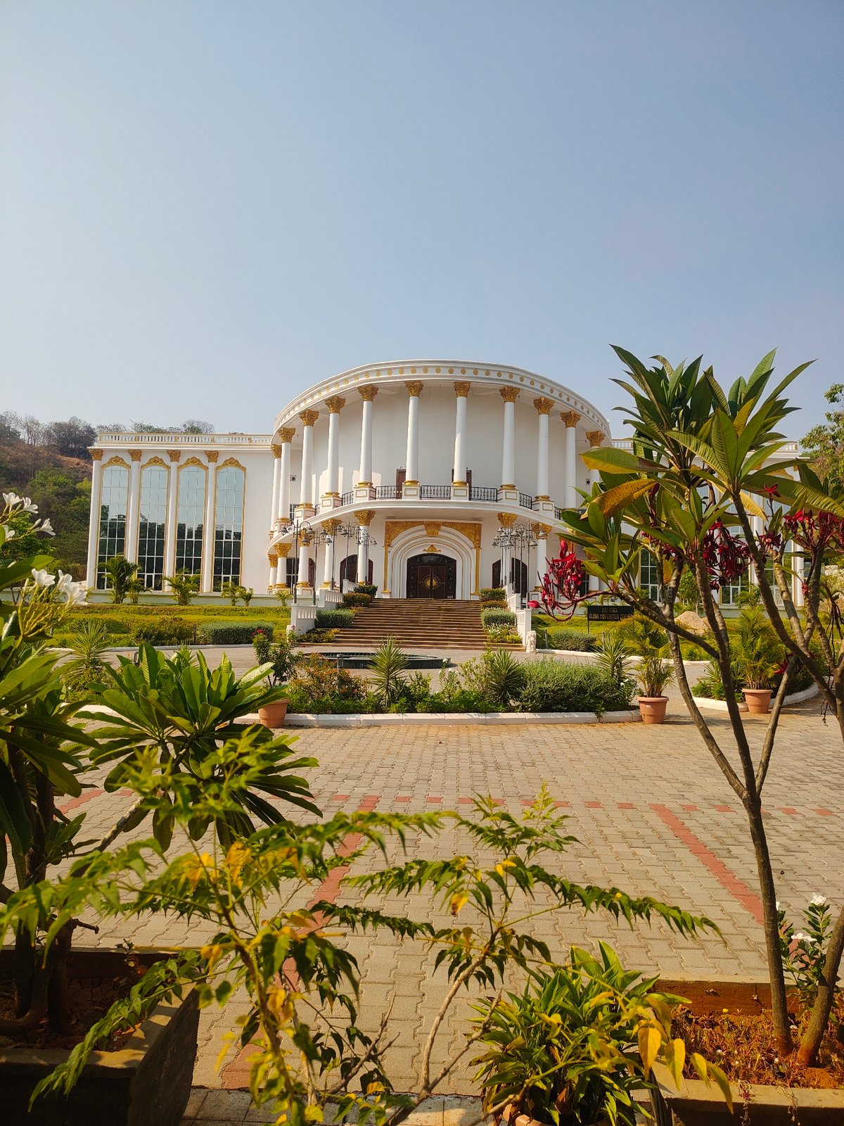 Classical white building with gold trim documented in Puttaparthi