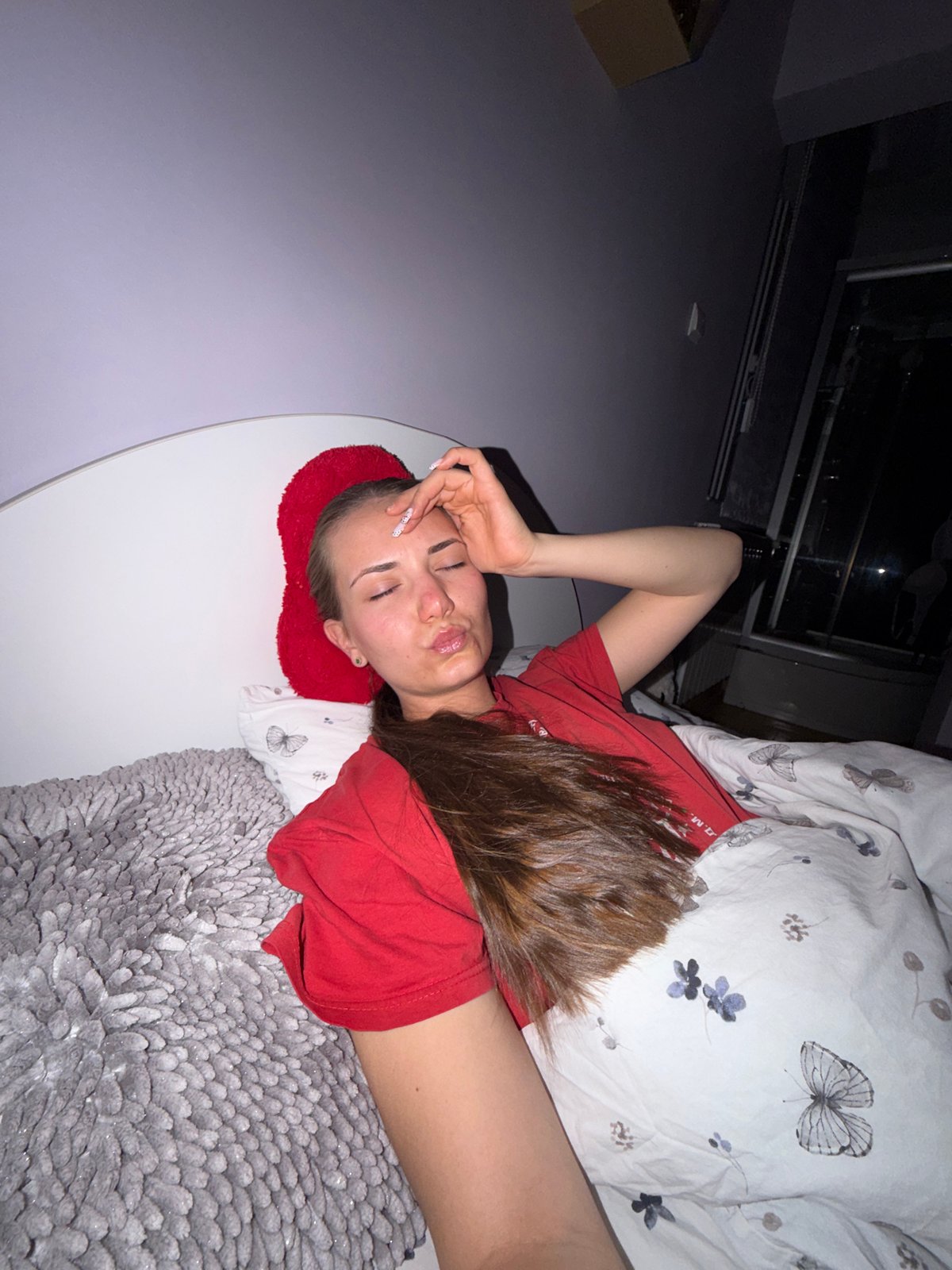 Woman rests on patterned bedding in Buhovo, Bulgaria