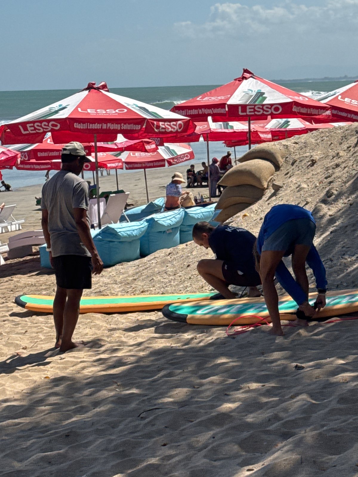 Kuta Beach morning: surfboards, snack vendors, and shoreside chairs
