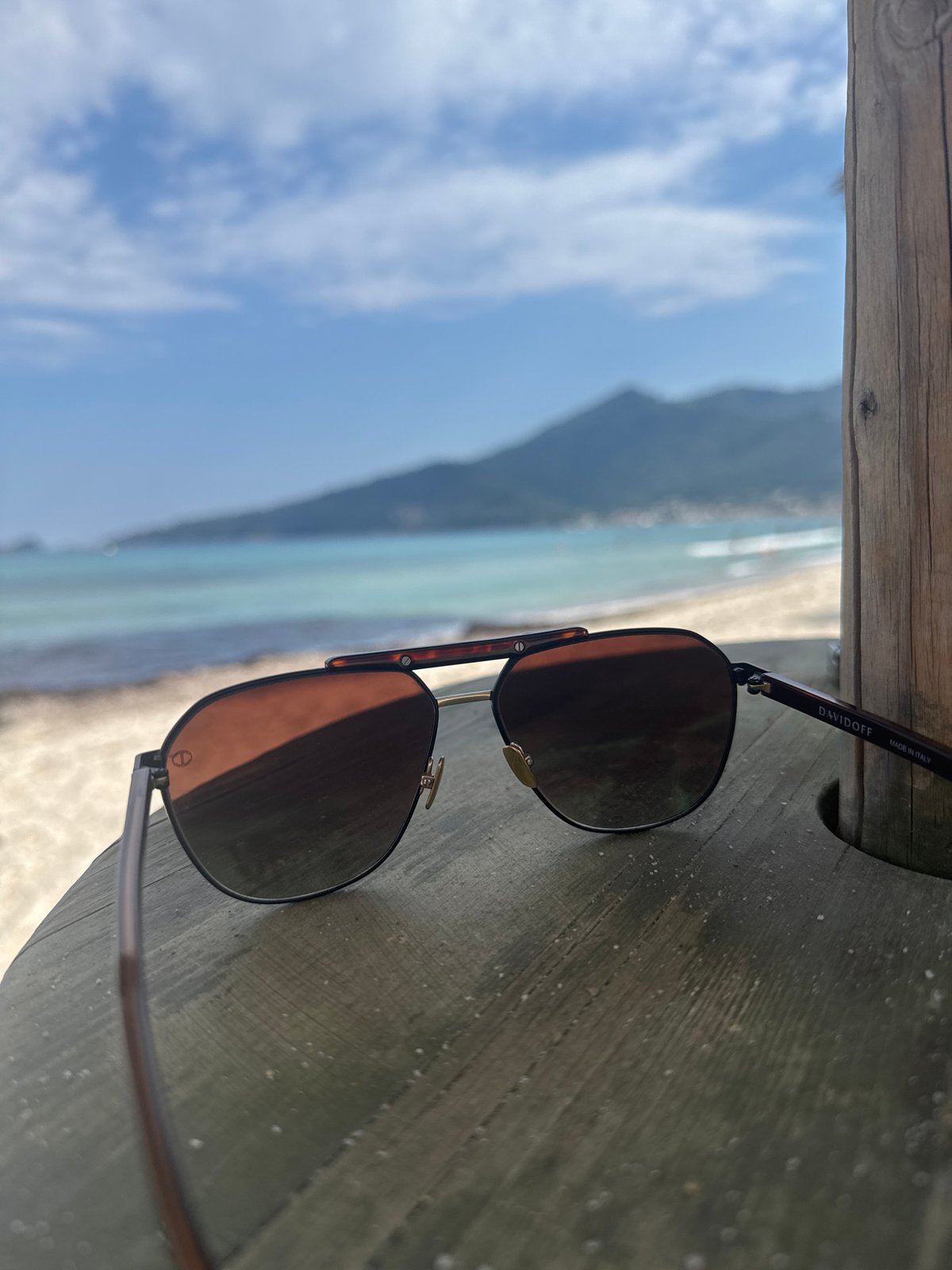 Beach visitor documents sunny afternoon through personal perspective shots
