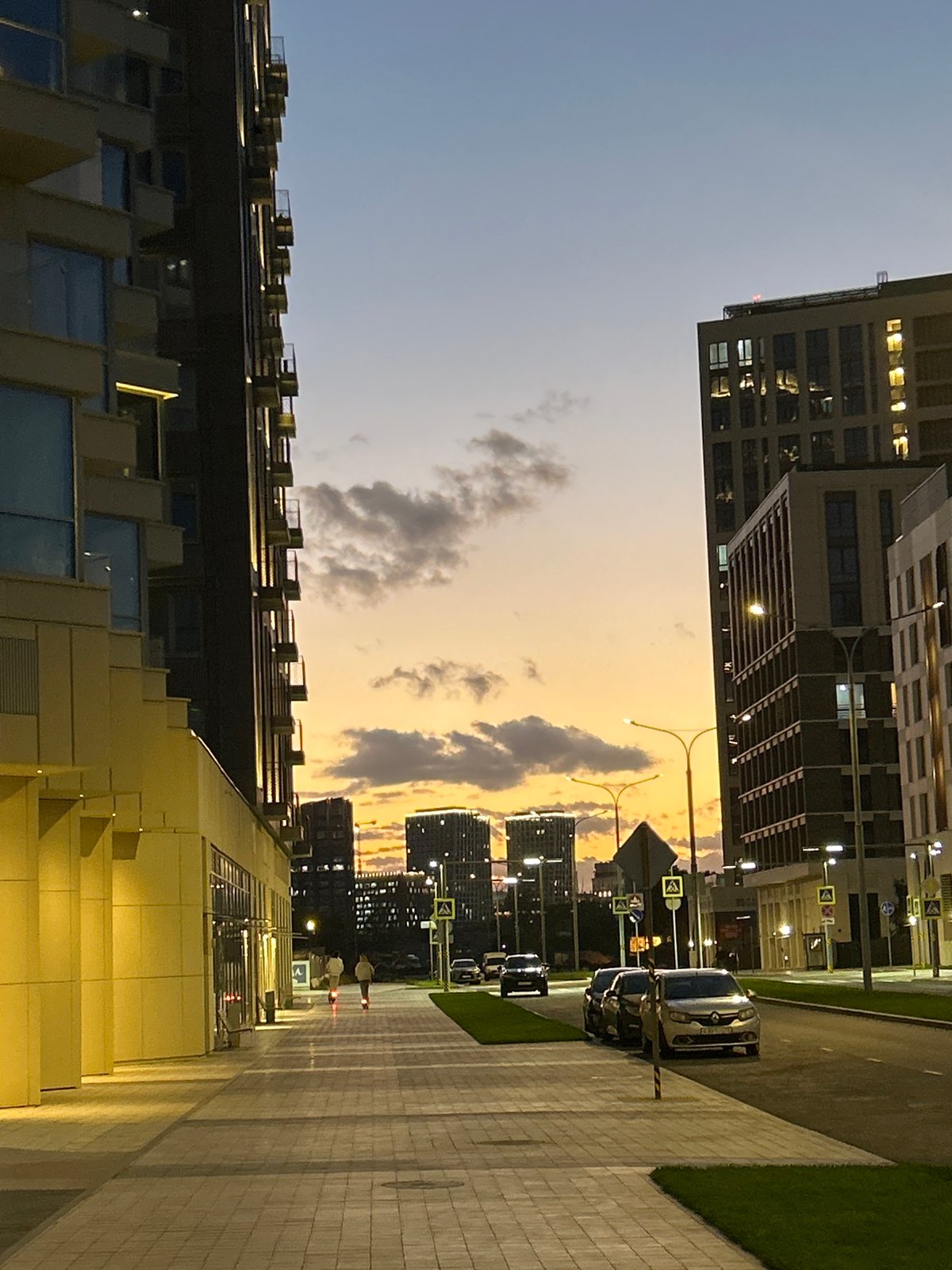 Modern apartment complex with playful outdoor playground at dusk