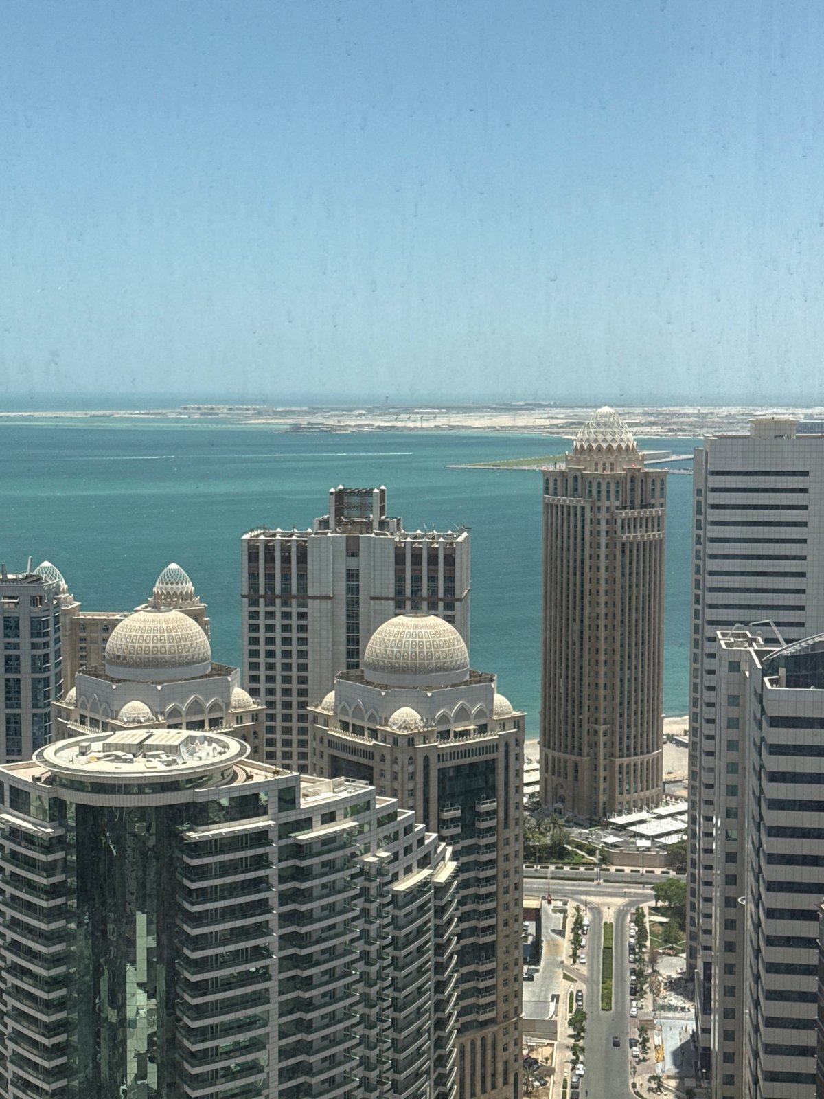 Morning skyline views captured from Doha high-rise windows