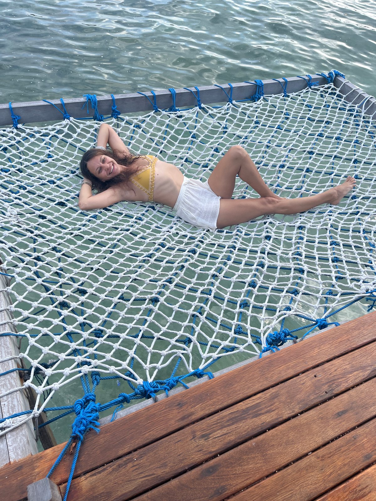 Relaxing on a net hammock over turquoise water in Nusa Penida