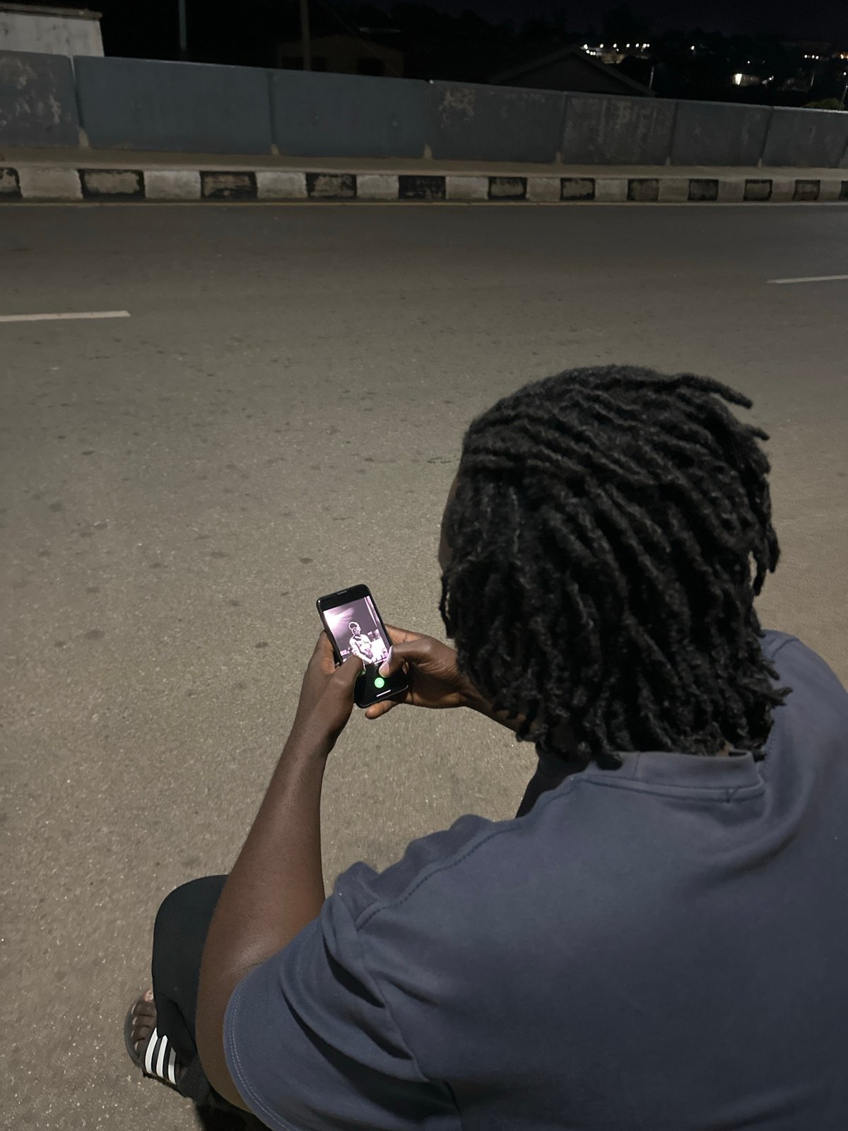 Hanging out on a lit street in Jos at night