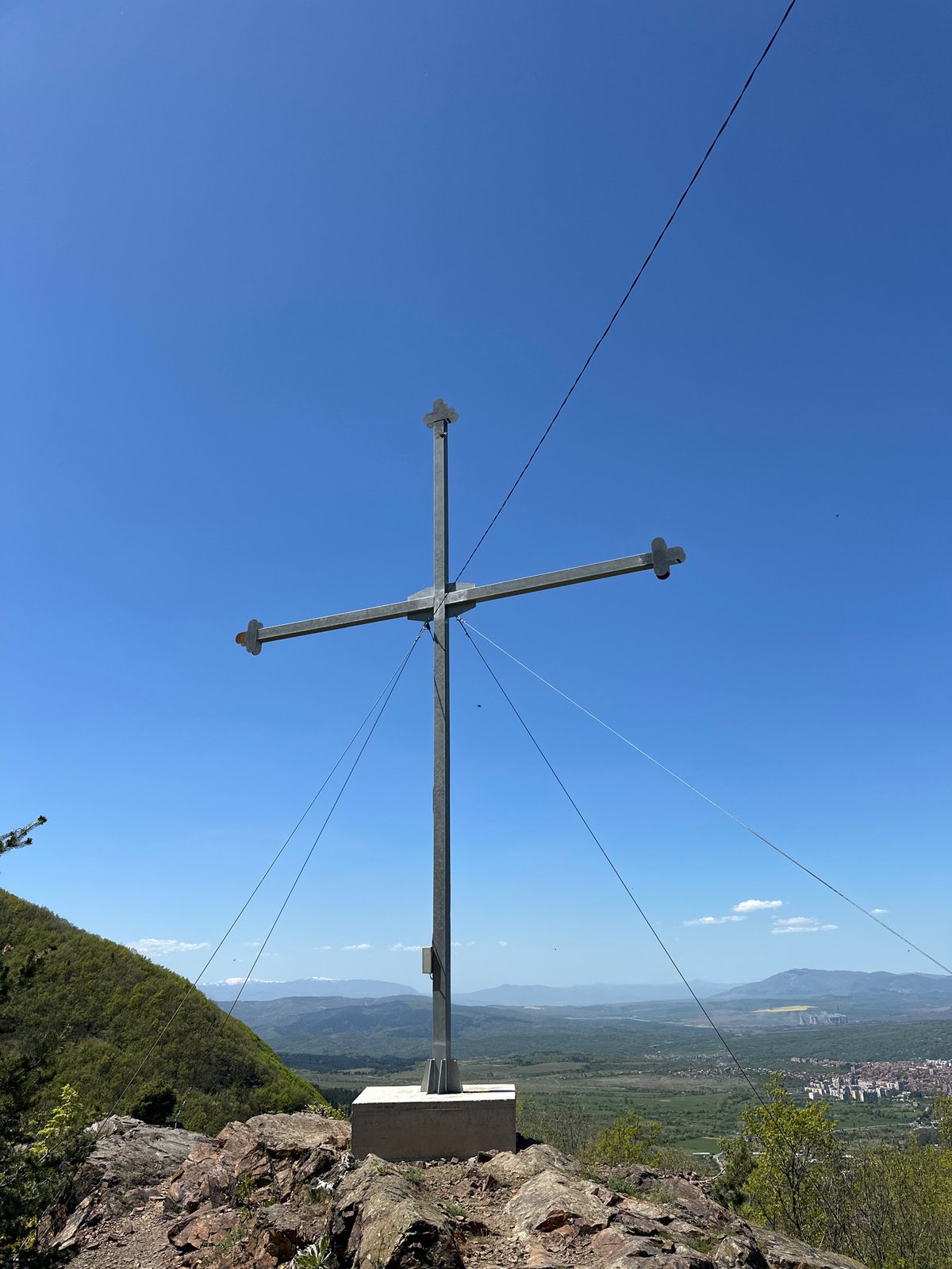 Visitors gather at hilltop cross overlook in Bistritsa, Bulgaria