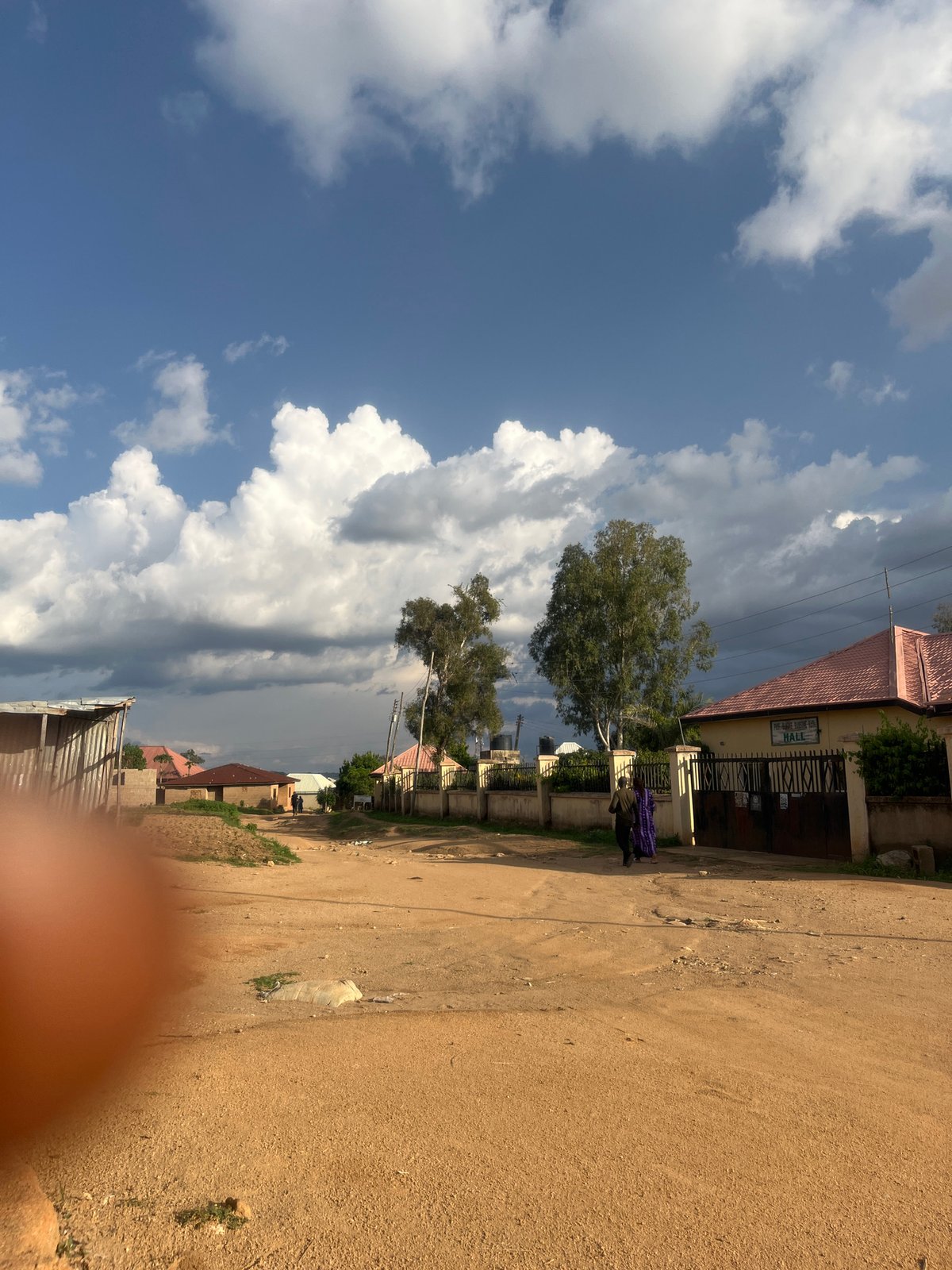 Daily life captured on dirt roads in Nigerian community