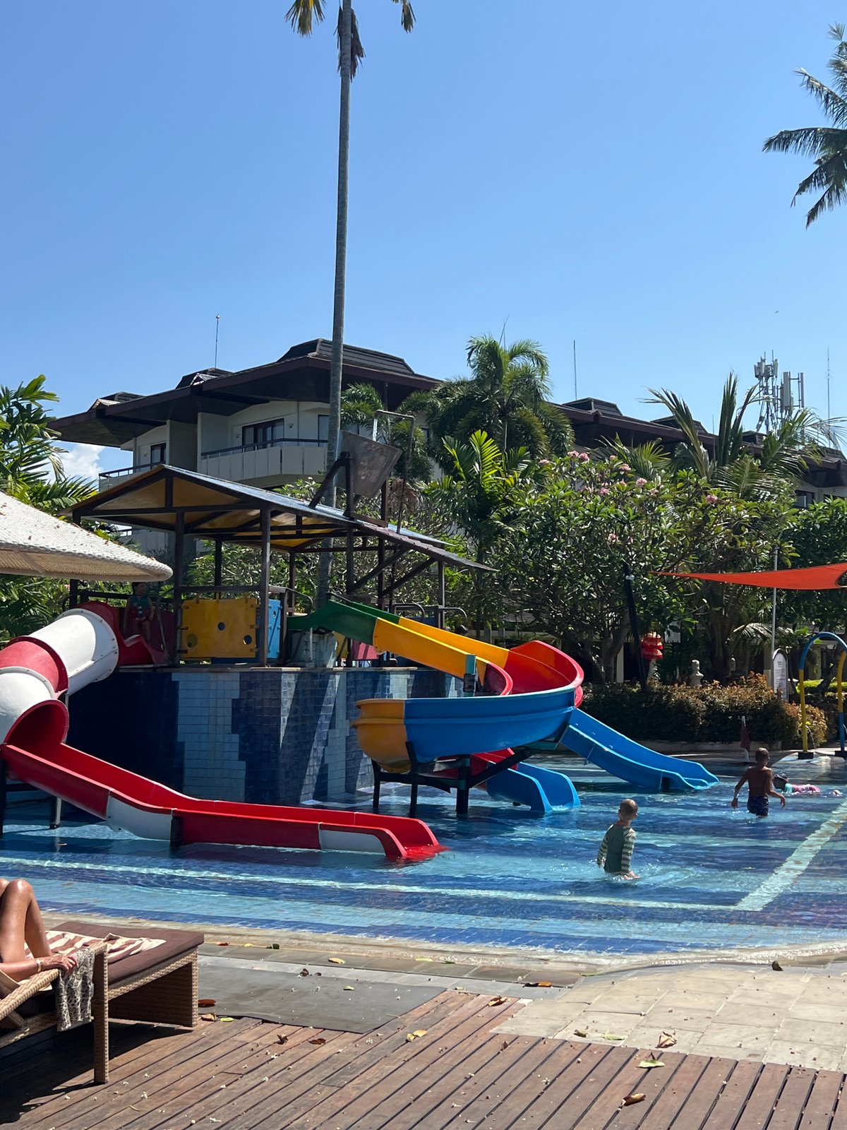 Beach resort morning in Denpasar — water park, surf school, and shoreline