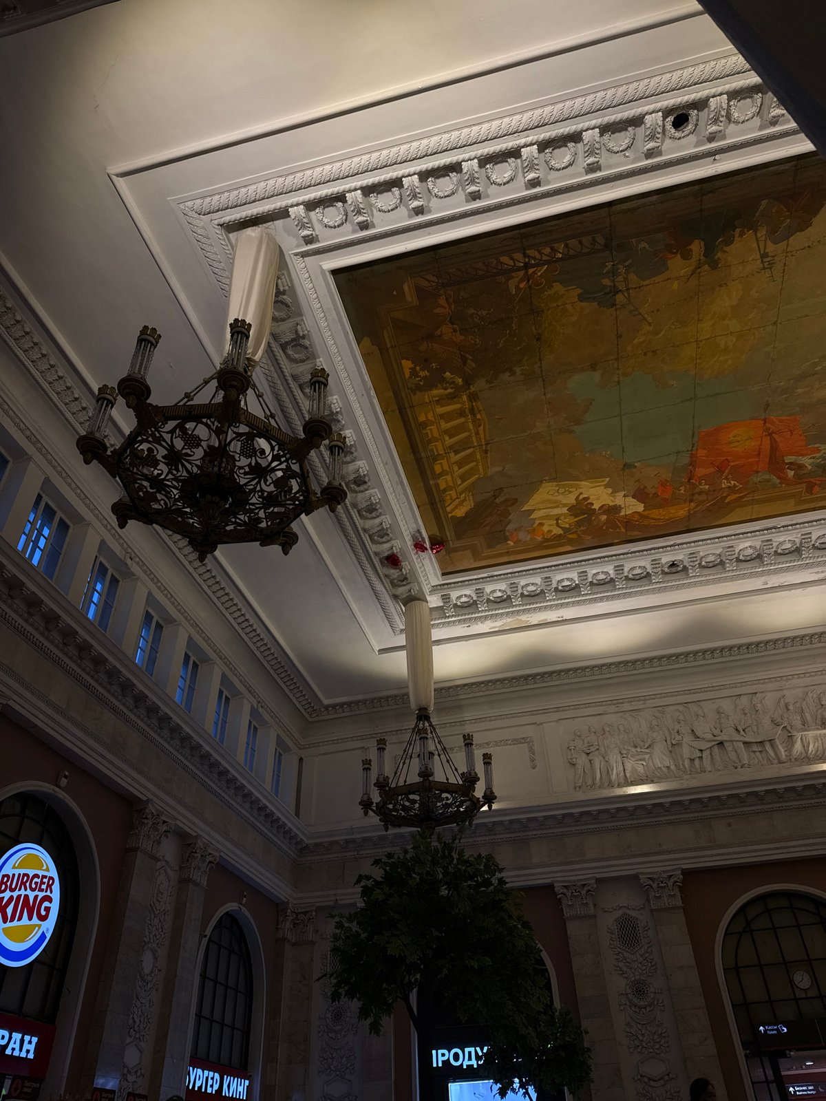 Visitor photographed in ornate Saint Petersburg building interior
