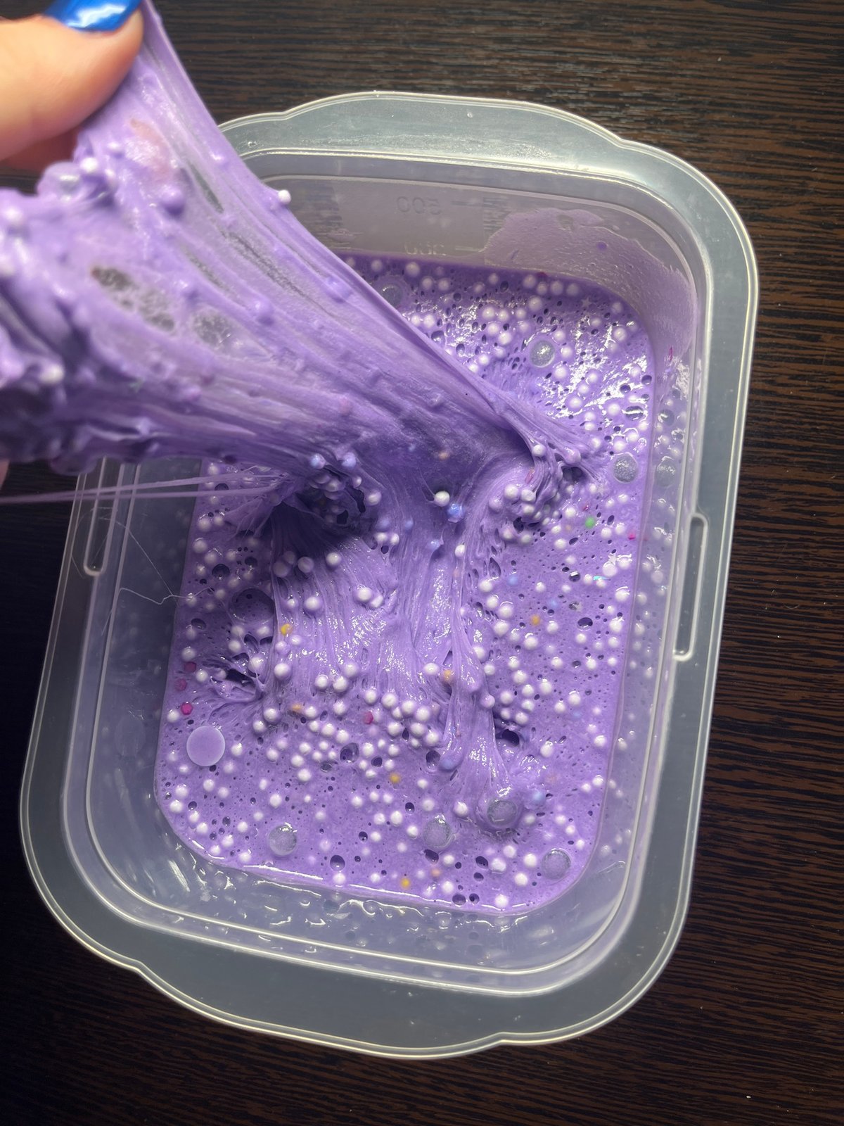 Person plays with purple slime in Saint Petersburg home