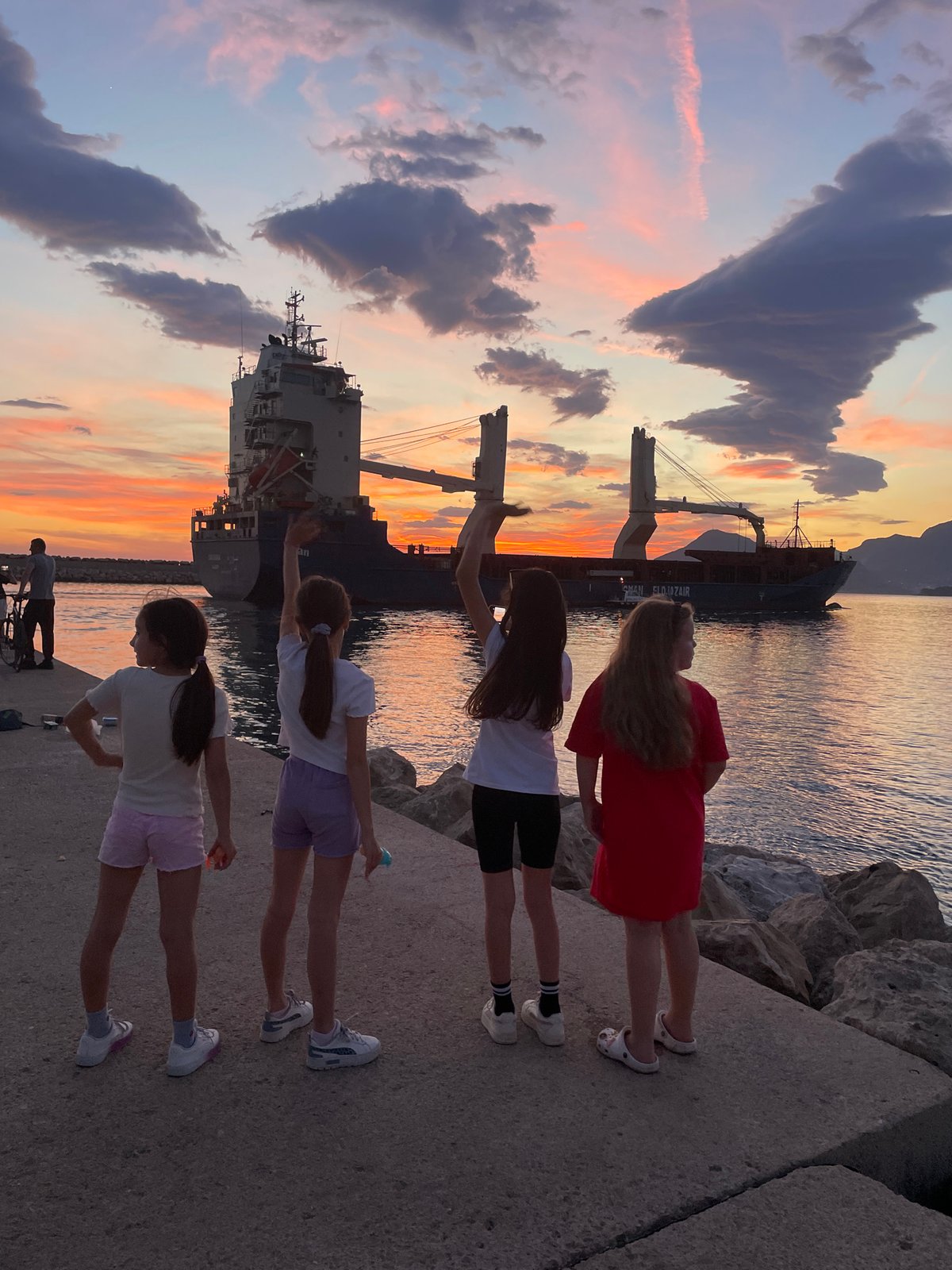 Sunset watchers gather at Bar Montenegro harbor pier