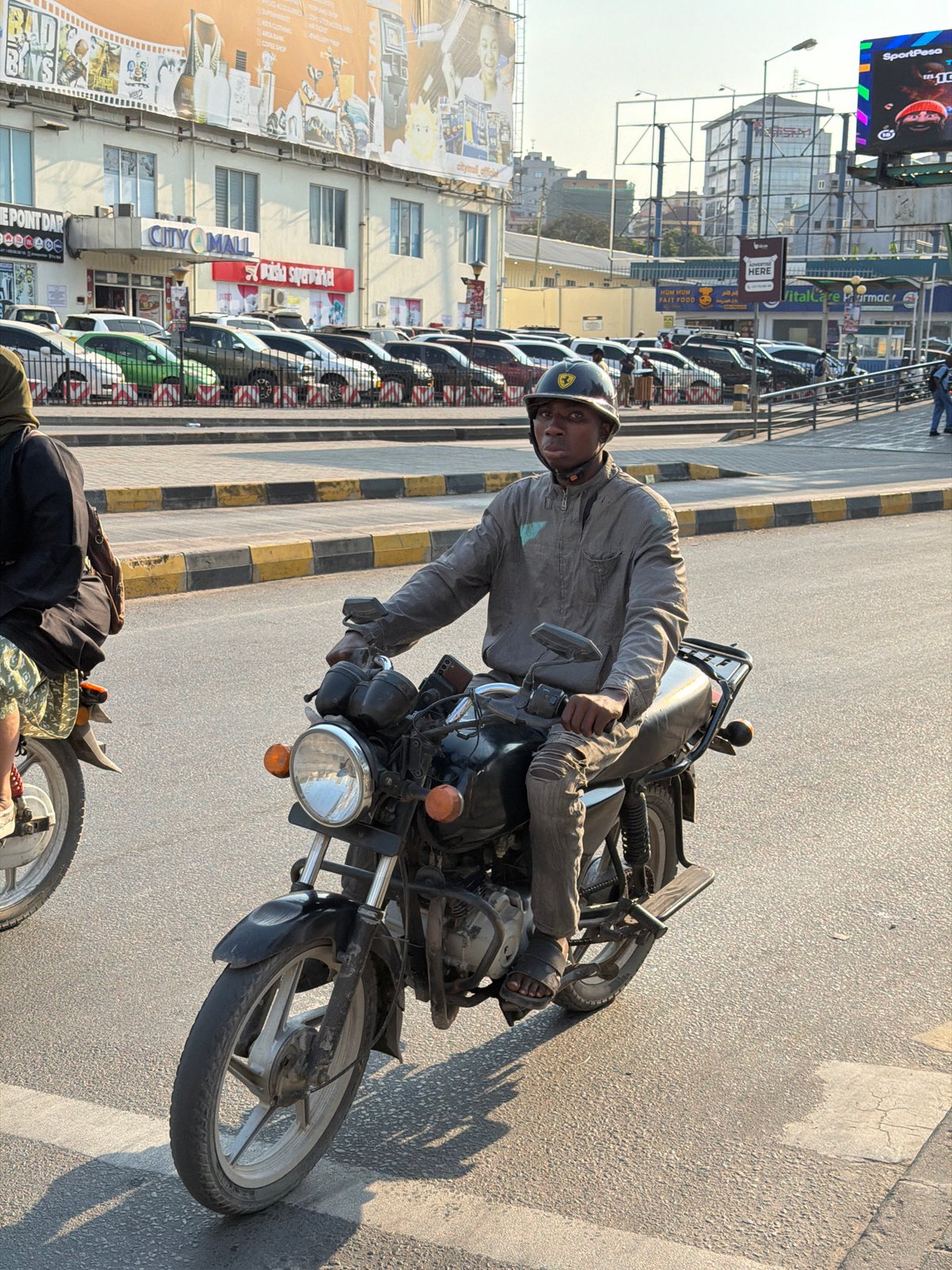 Midday street traffic and pedestrians moving through Dar es Salaam