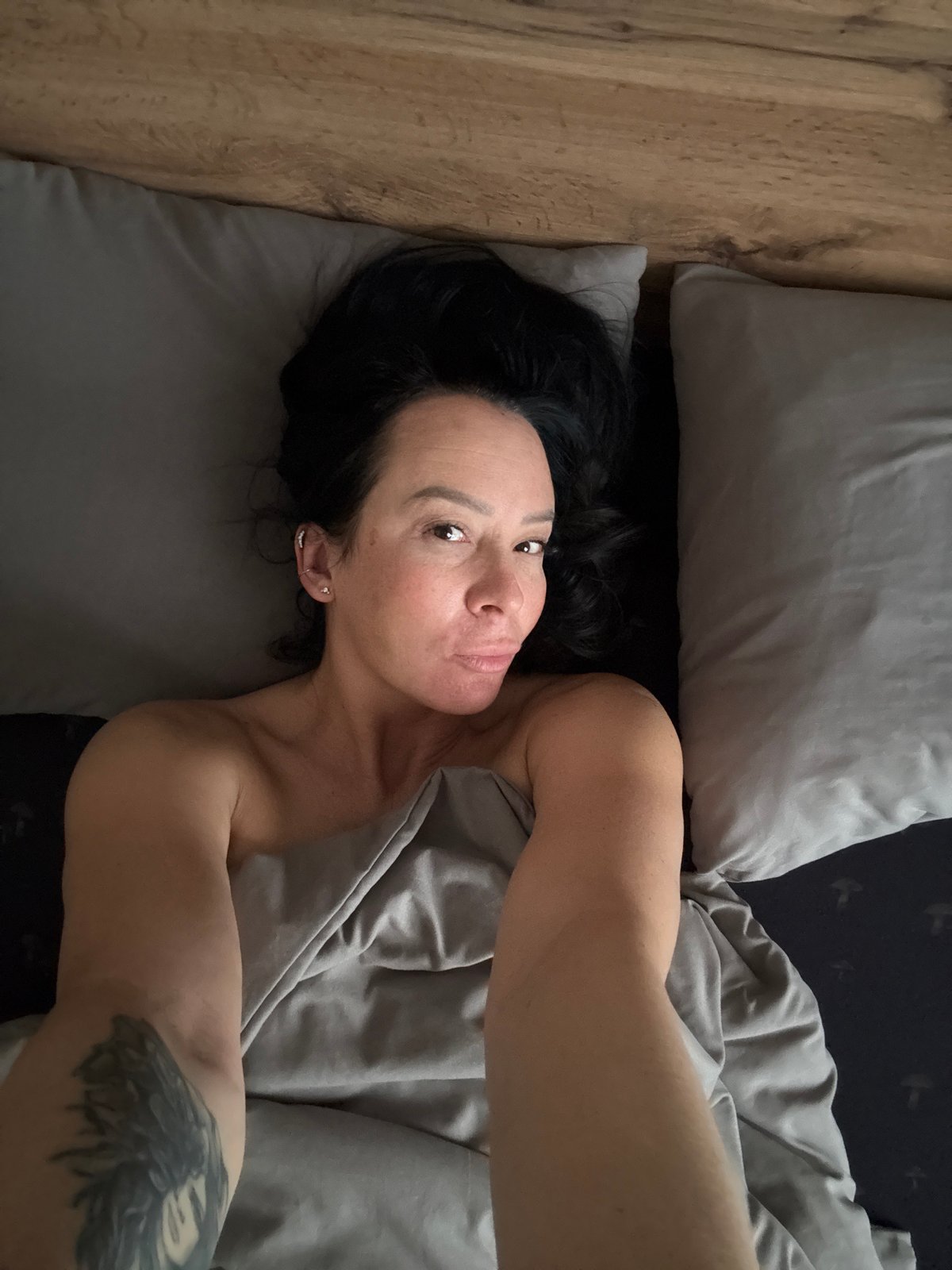 Woman and dog captured in quiet bedroom moments in Chaikovsky