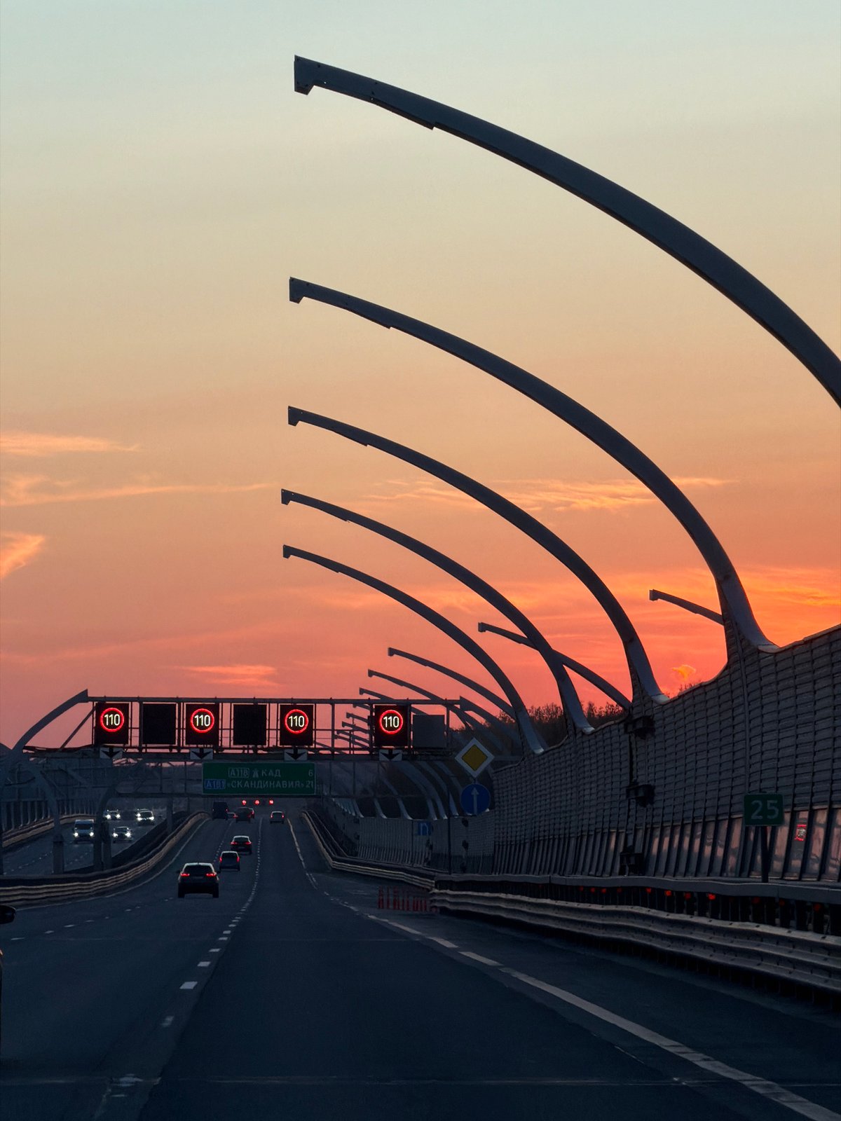 Evening traffic flows on Saint Petersburg highway at sunset