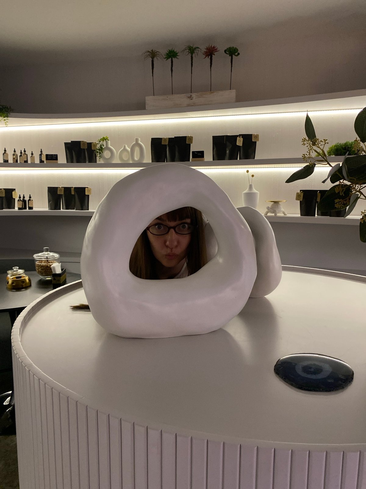 Woman peers through white ring object in Votkinsk store