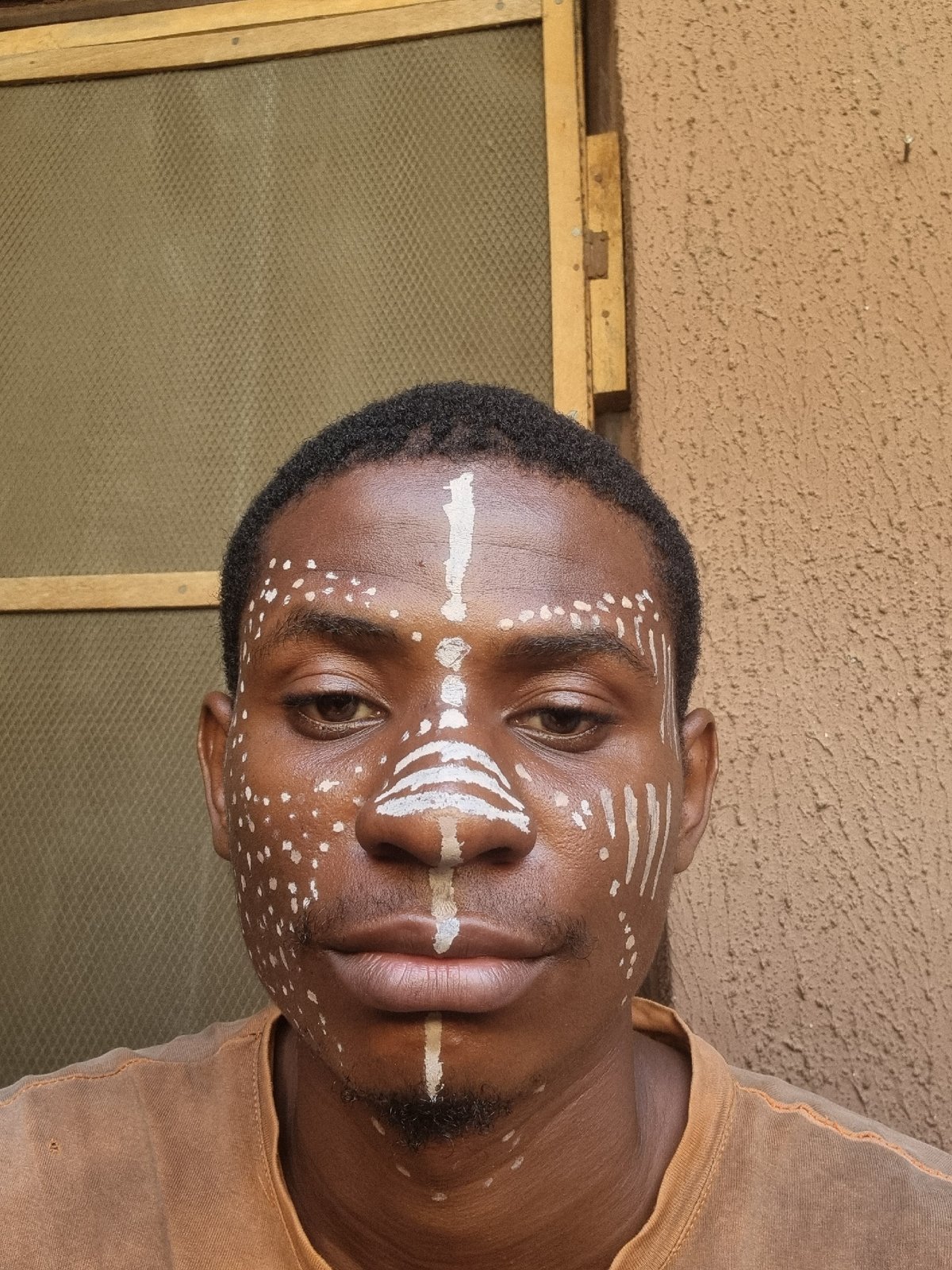 Person spotted wearing traditional white geometric face paint patterns