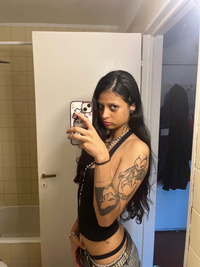 Person documents selfie session with piercings in Buenos Aires bathroom